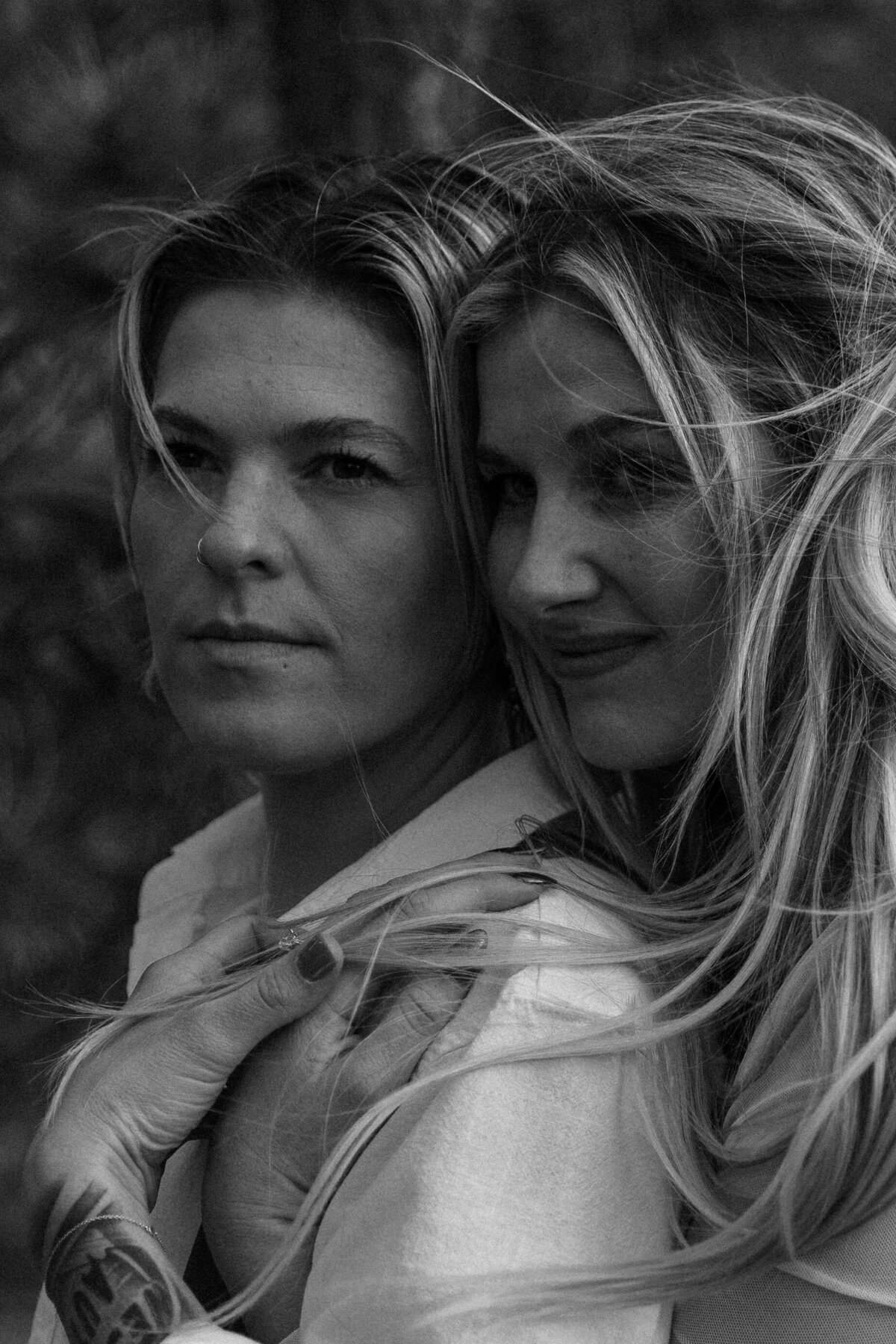 Close up black and white photo of a female couple at Lily Lake, CO 