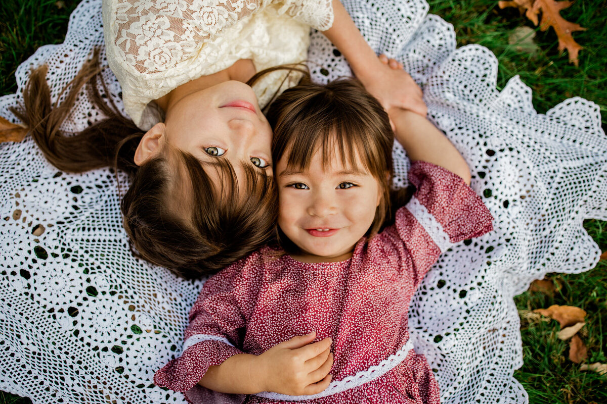 Little girls laying on blanket in Echo Lake Park