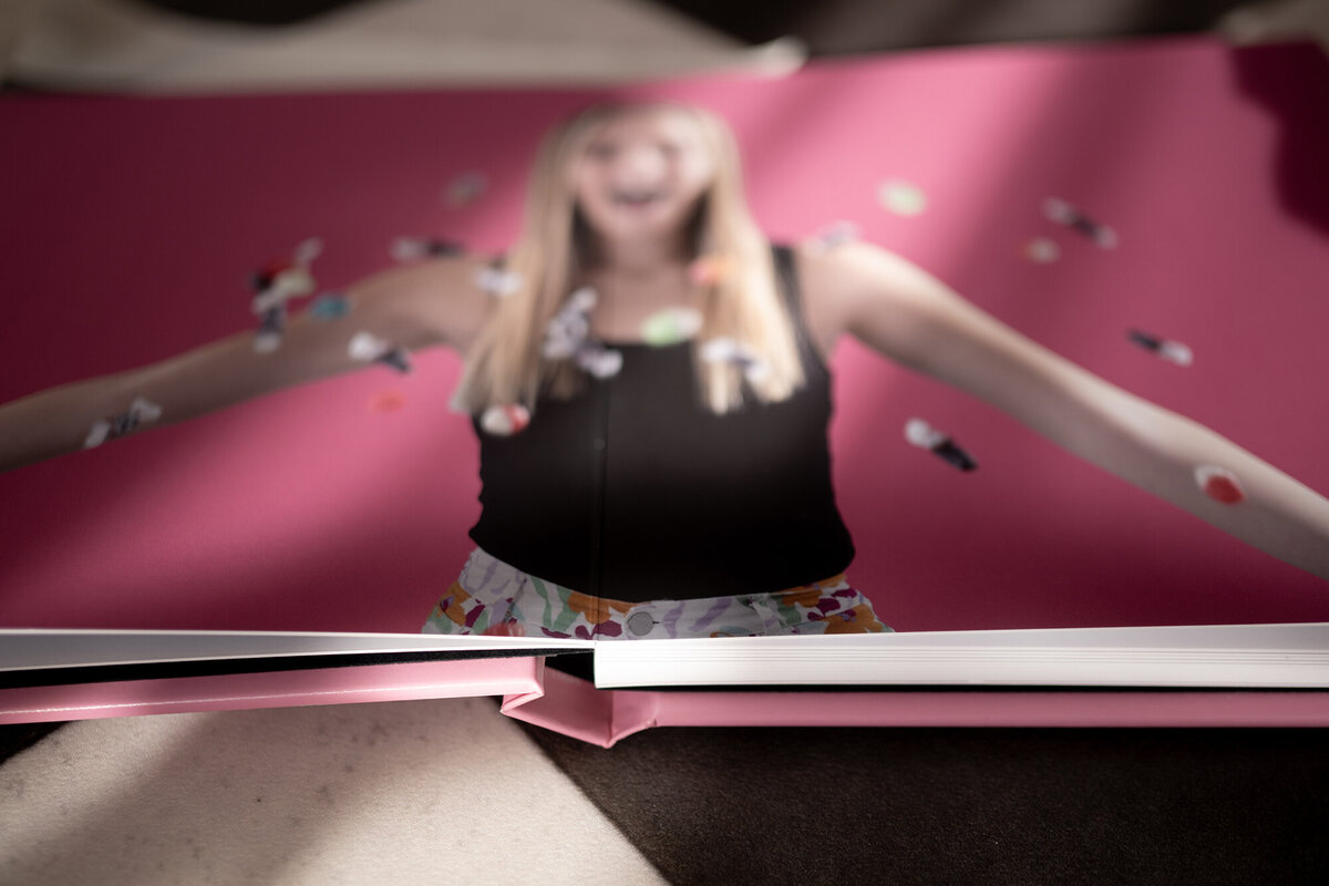 Details of an open photo album's pink binding
