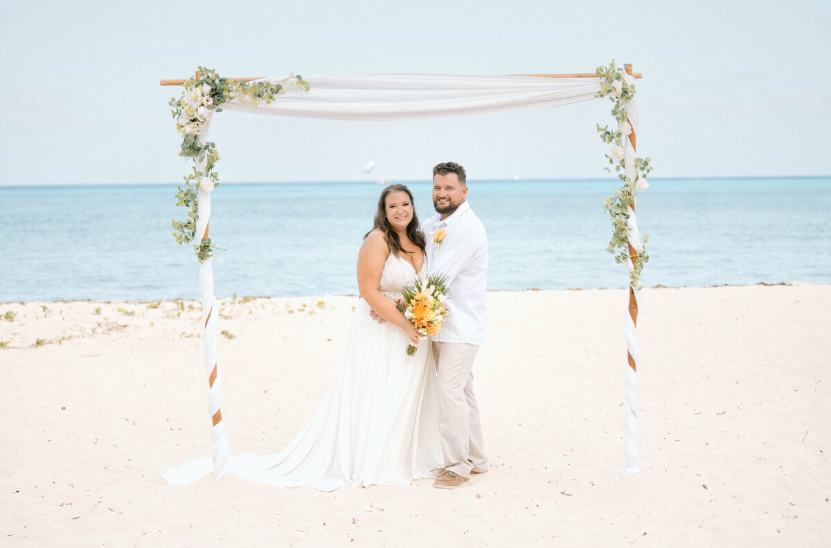a bride and groom on the beach in Cozumel