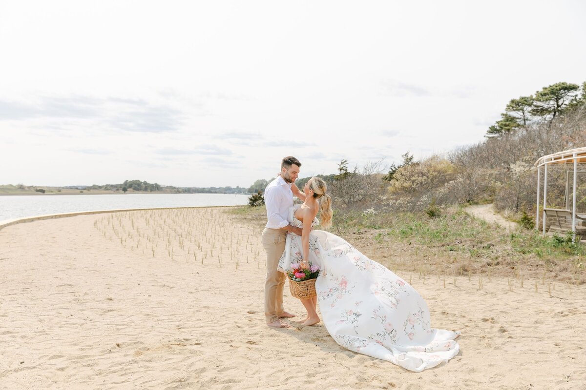 Bride and groom hug on beach