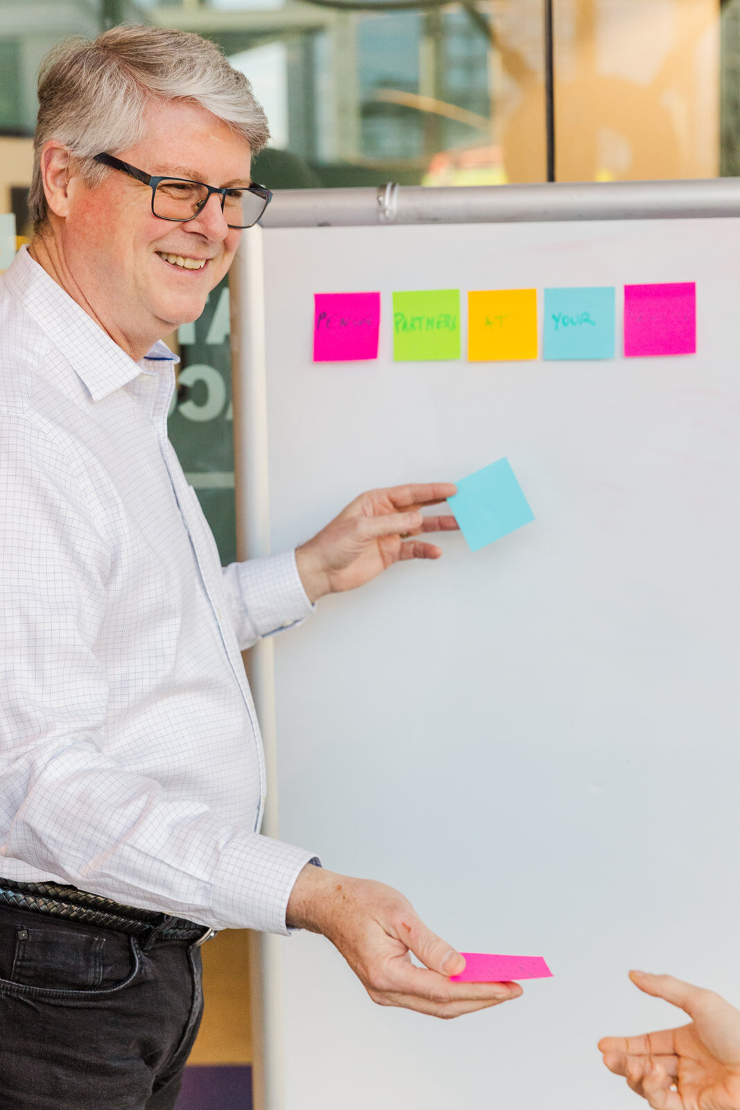 consultant talking during a meeting in front of a white board with post it on it in modern office Atlanta personal brand photographer | Laure Photography branding