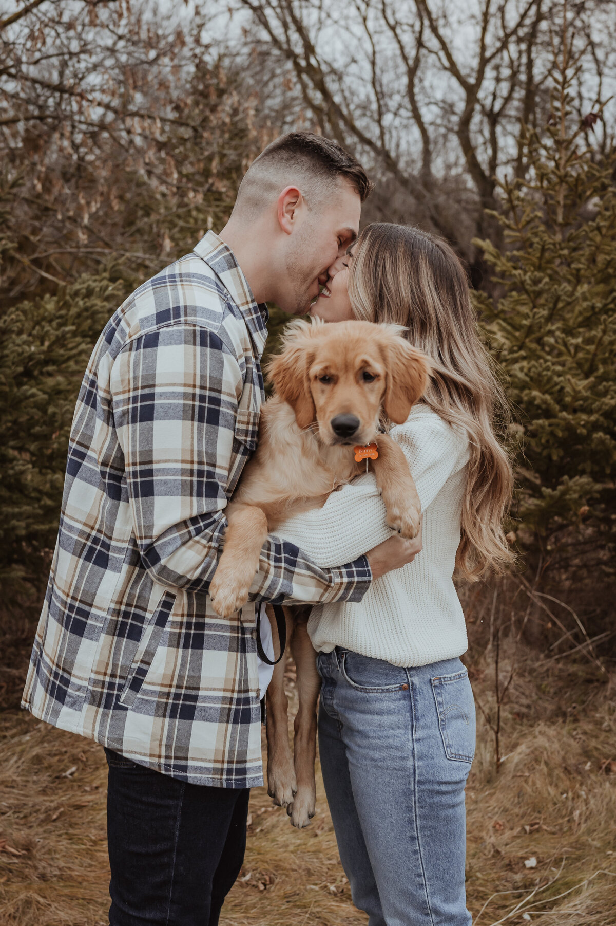Couple embracing a puppy
