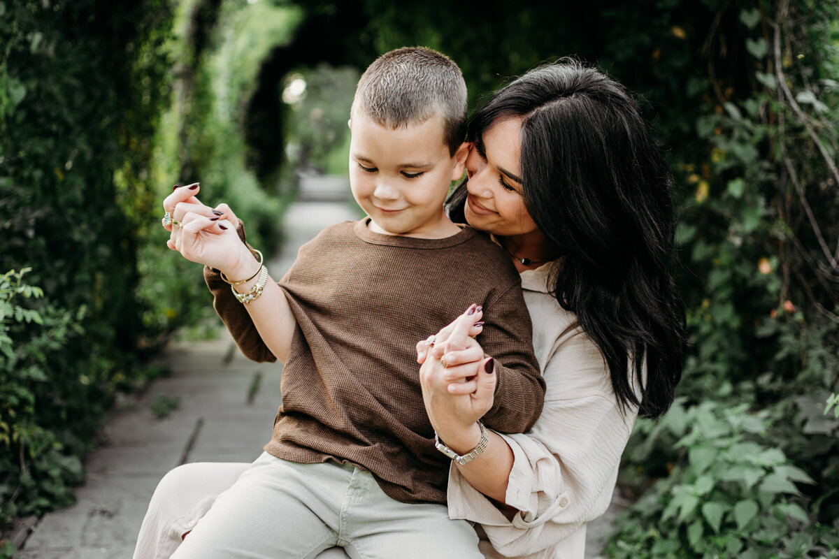 Mom sharing the love with one of her boys during a family photoshoot in Fabyan Forest Preserve, IL