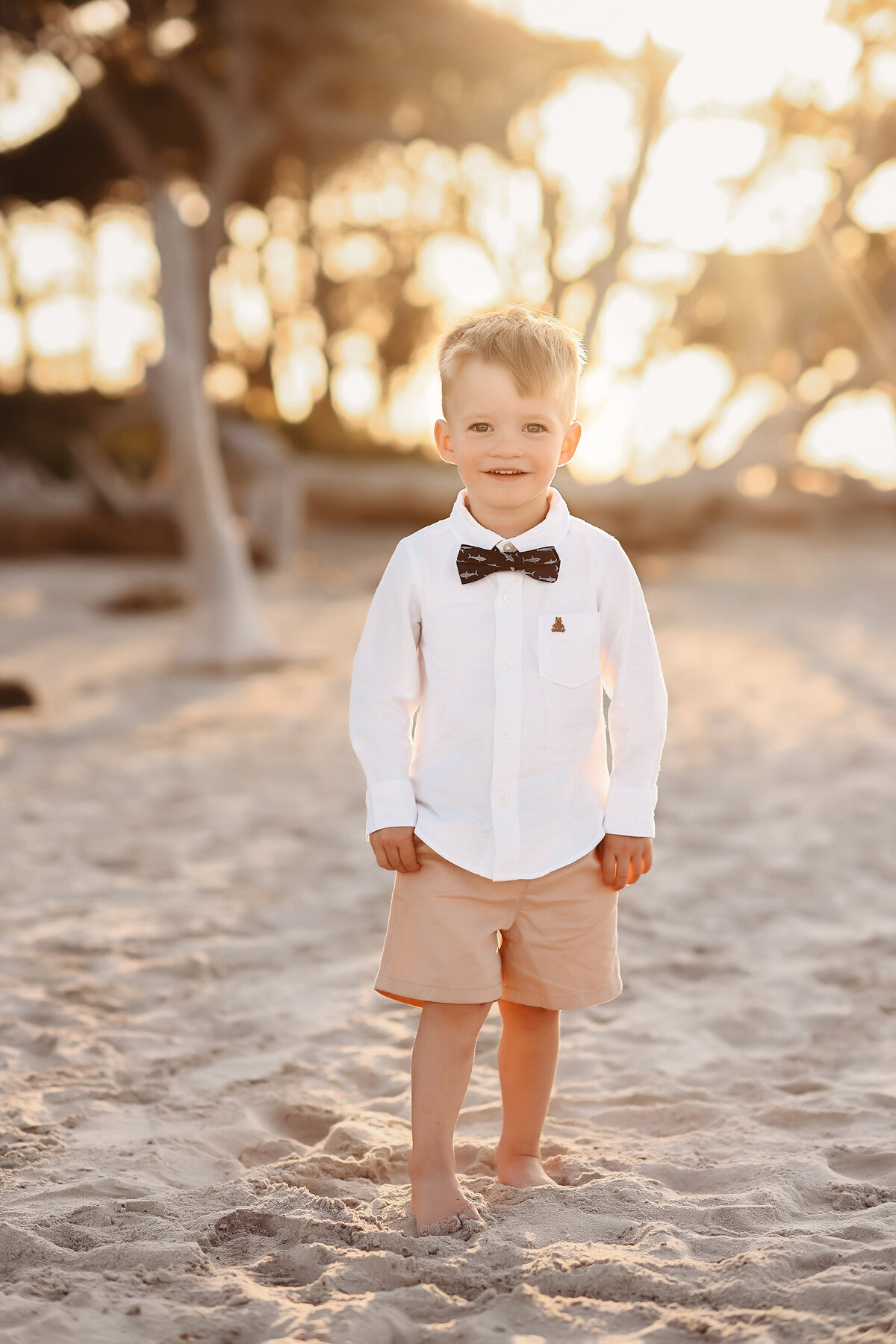 Little boy smiles at the camera during Family Pictures on Folly Beach. 