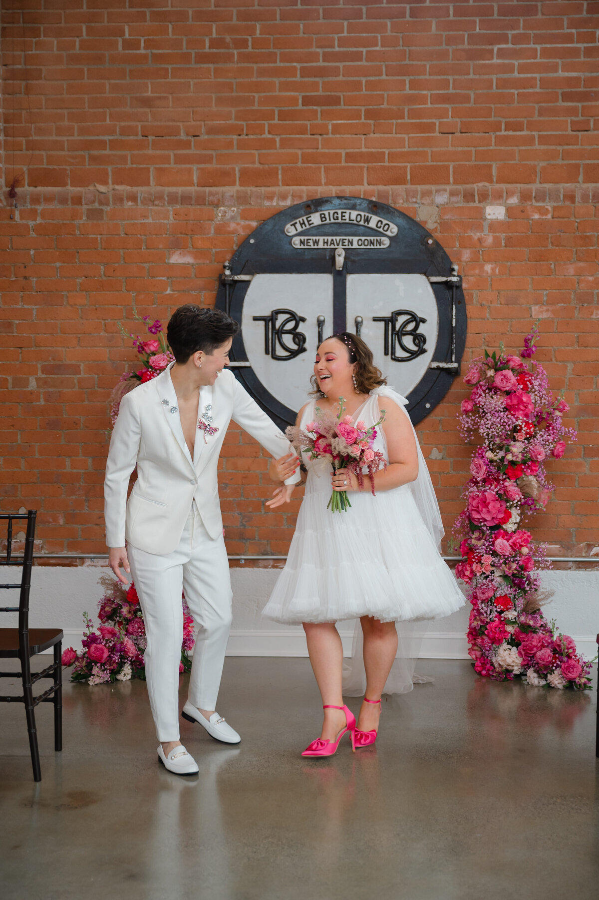 Two brides walking down the wedding aisle