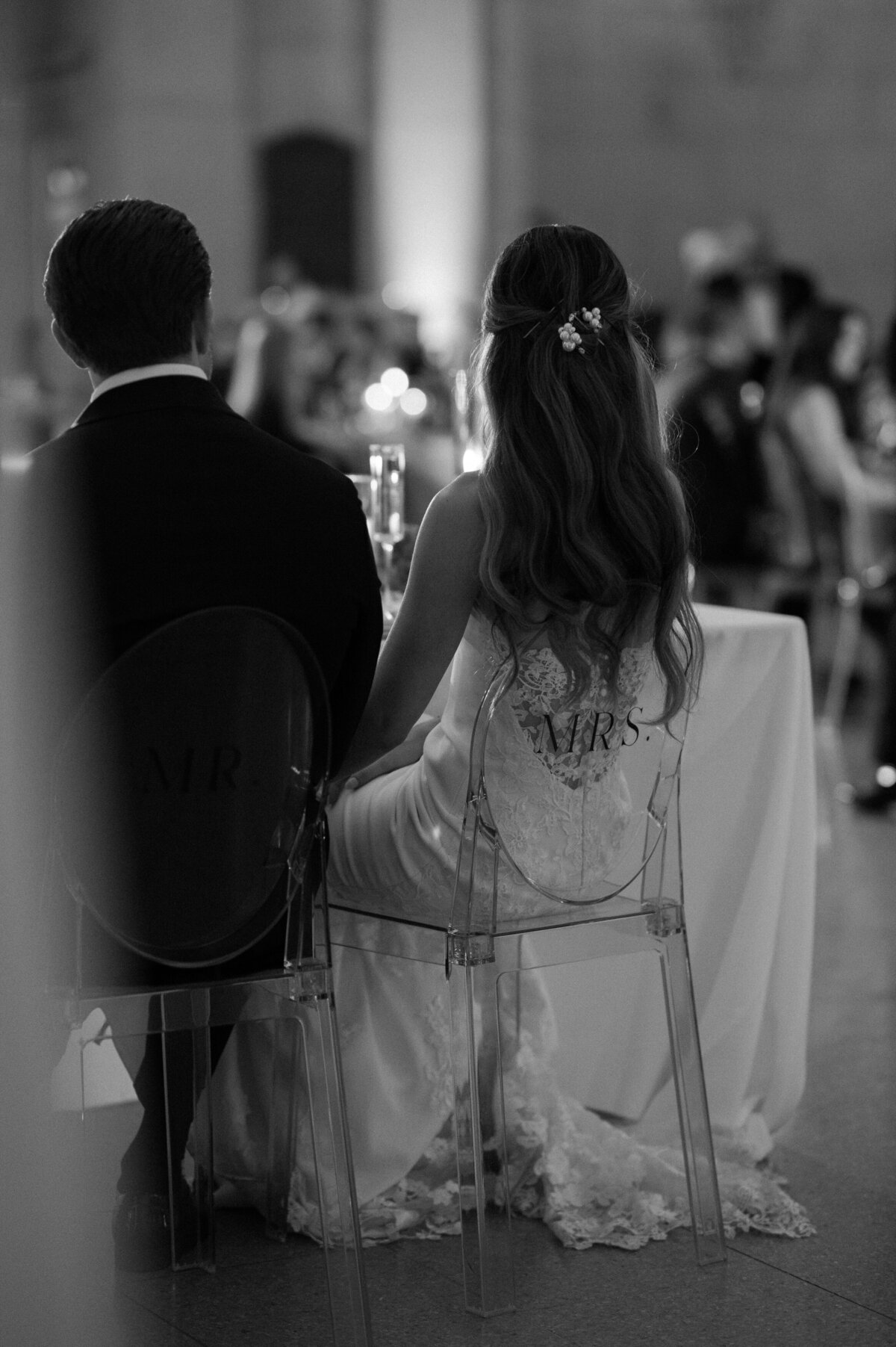 Newlyweds sitting at their reception table 