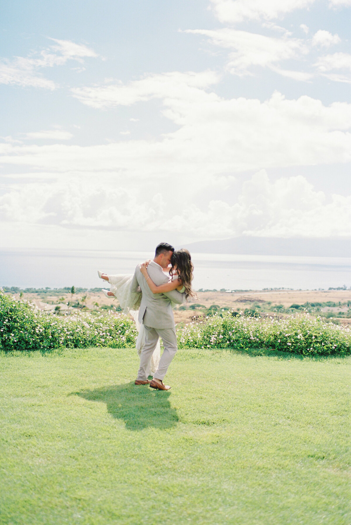 groom picking up bride