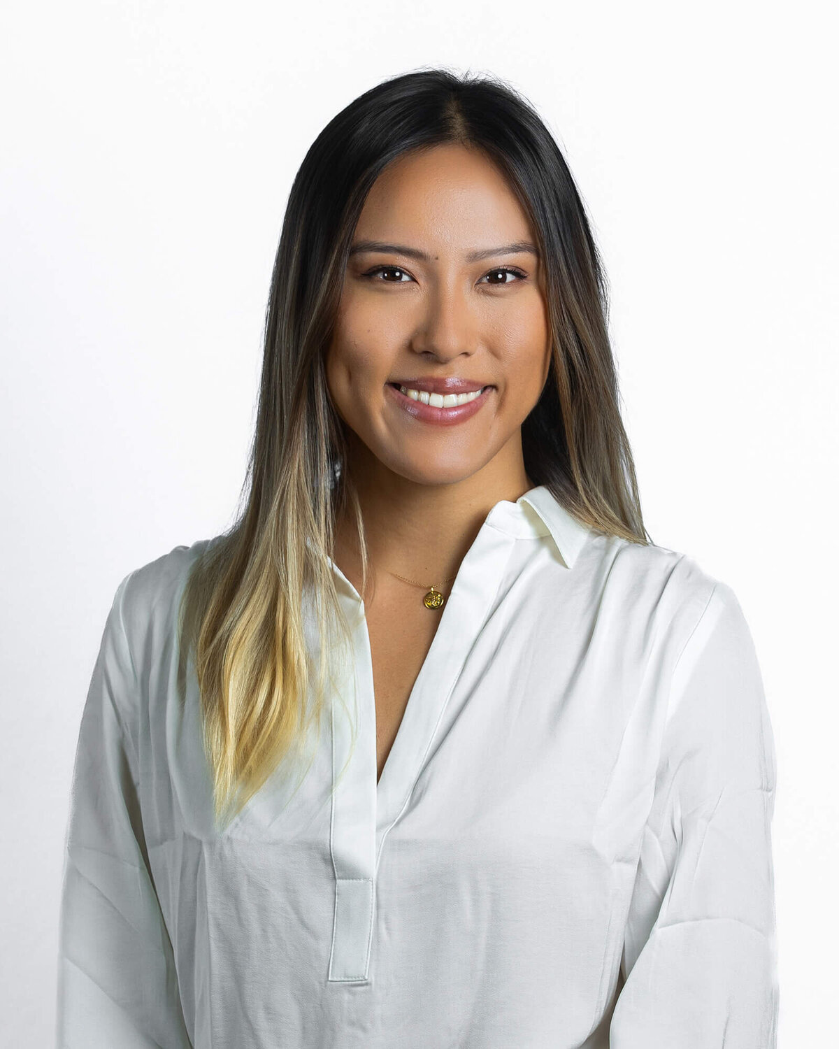 professional-headshot-woman-white-blouse-clean-background