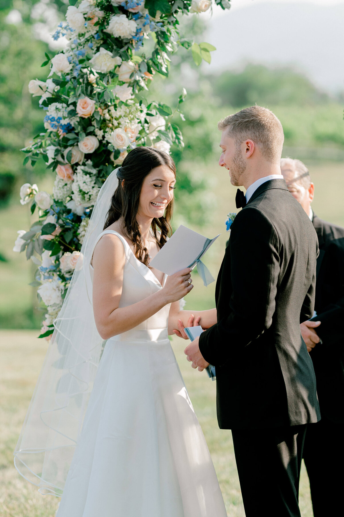 Bride happily reading her vows to her groom during their wedding ceremony