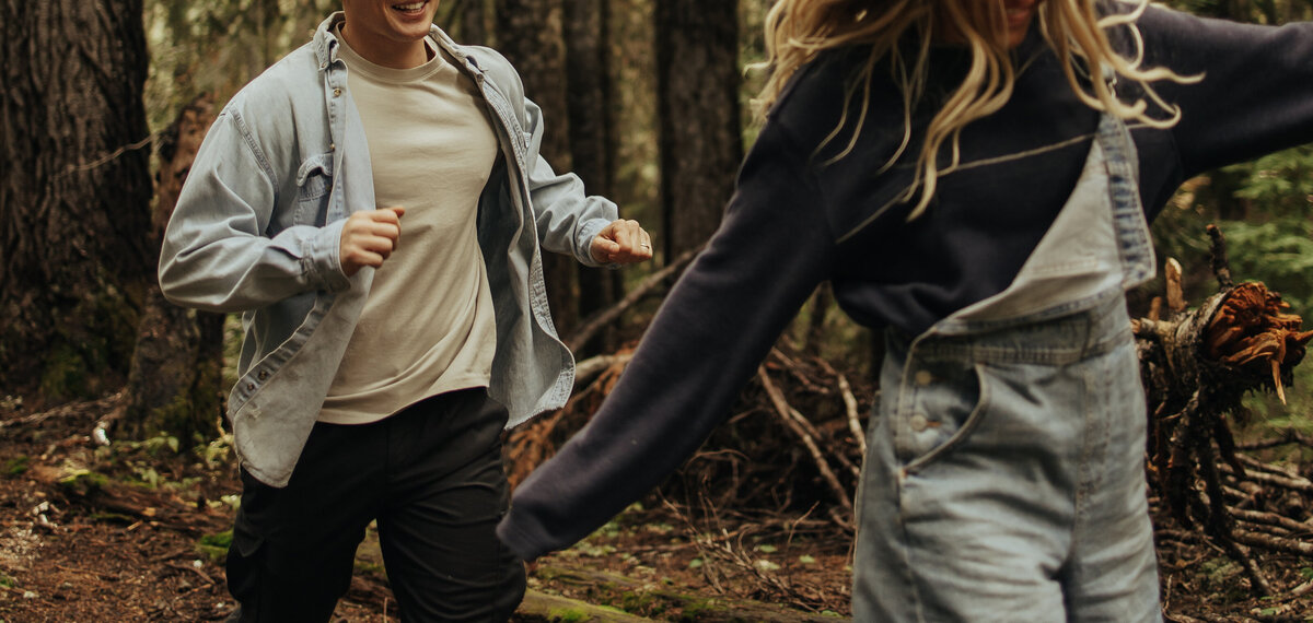 A man chases a woman through the forest in Mt. Rainier