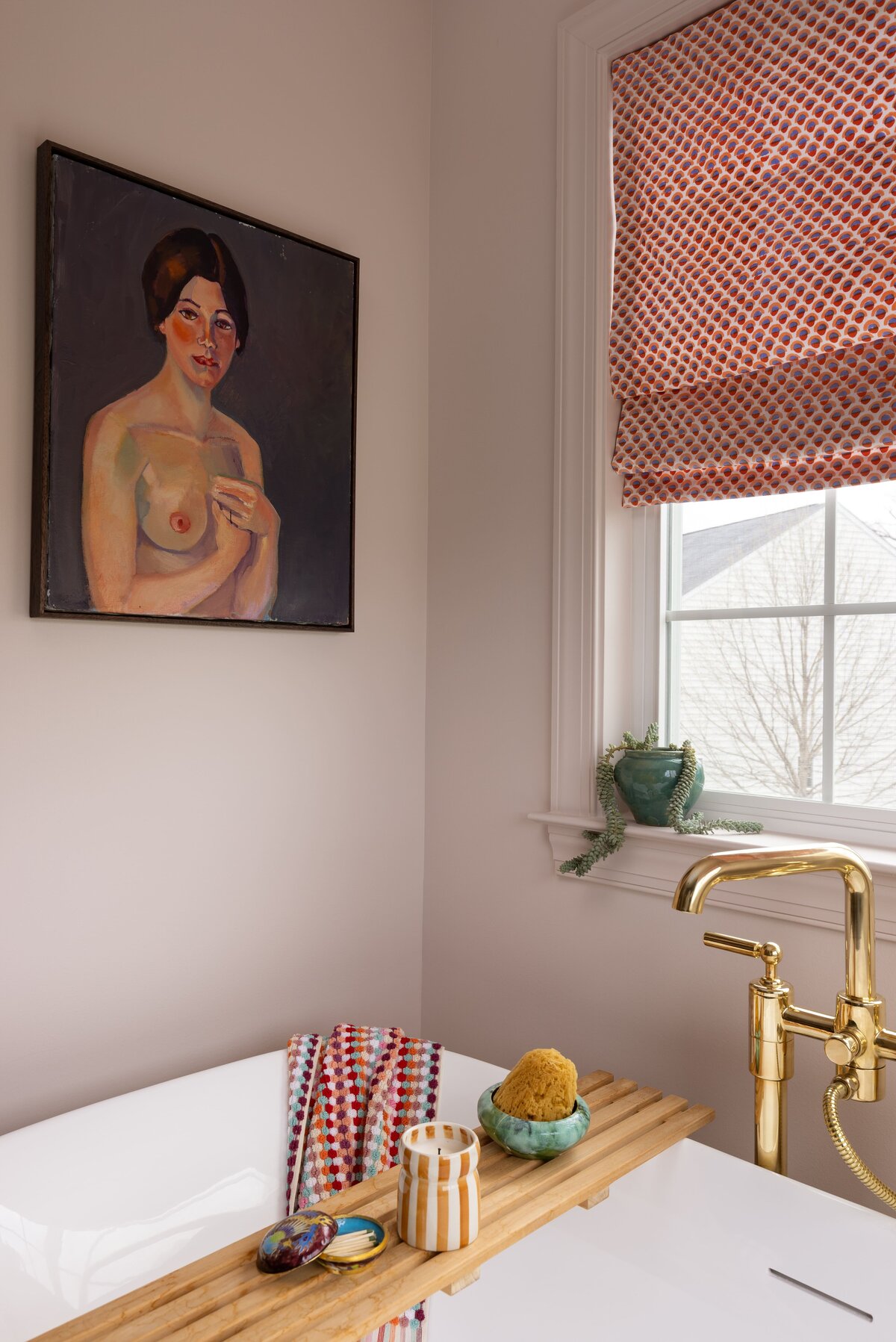 Bathtub area with eclectic wall art in a colorful primary bathroom remodel