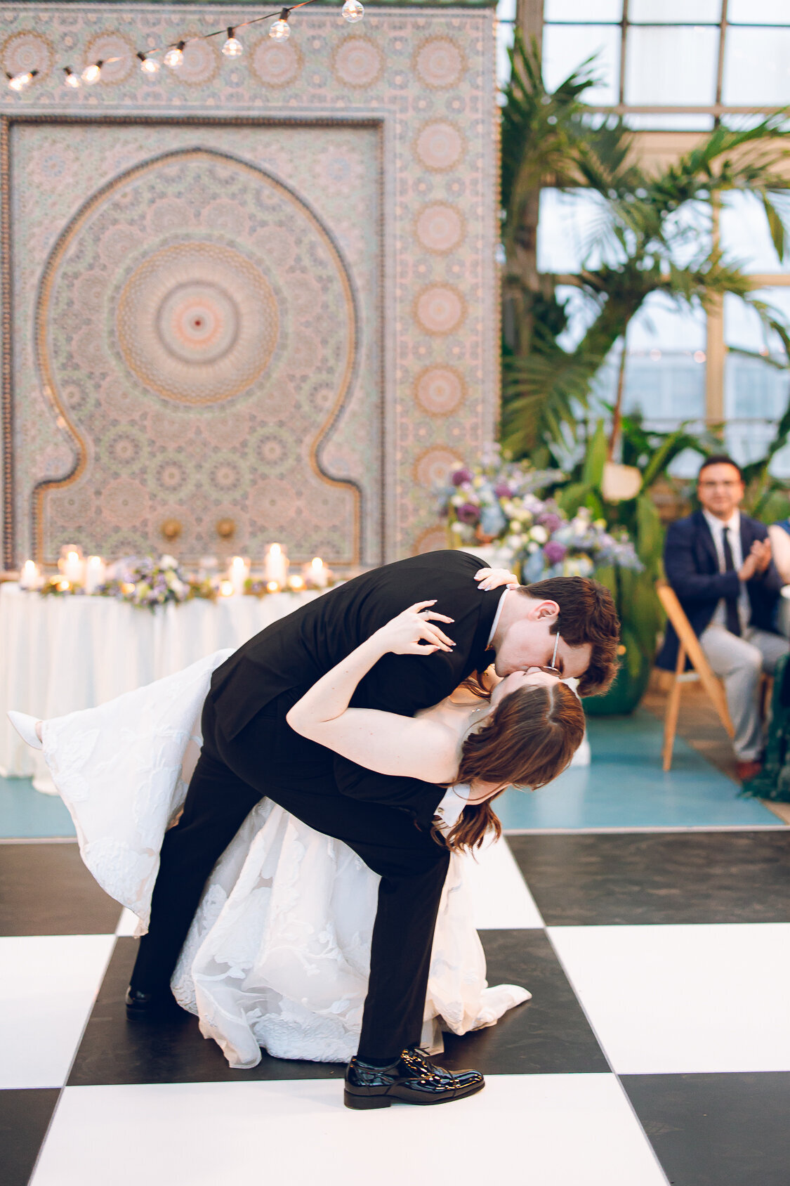 A couple shares their first dance on their wedding day at the Garfield Park Conservatory in Chicago
