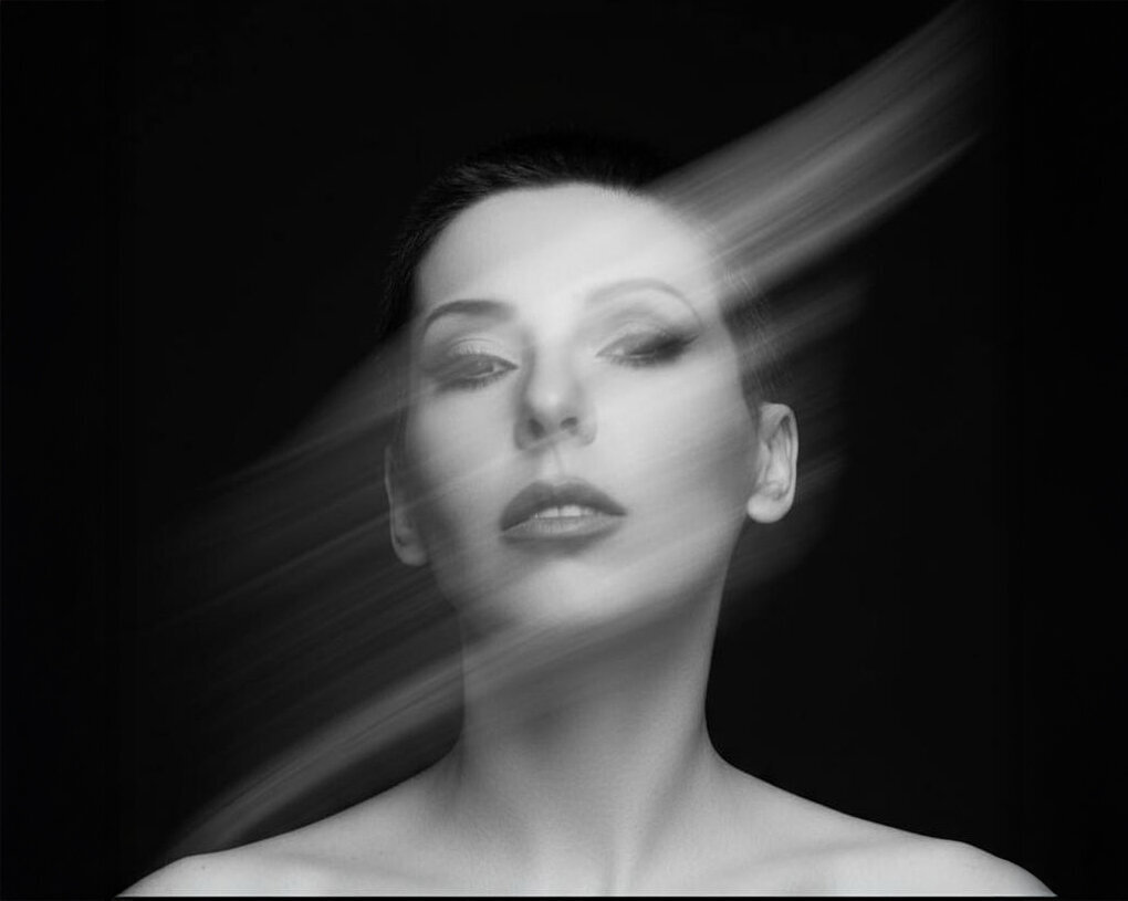 Fine art portrait of Jasmina Kimova in motion blur, symbolizing identity transformation and frequency shift for the Quantum Leap Energy masterclass