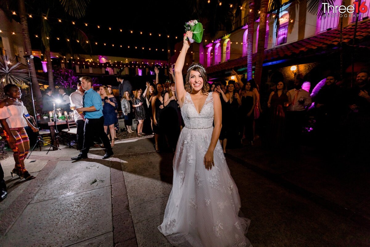 Bride tossing the bouquet into the air to waiting single ladies