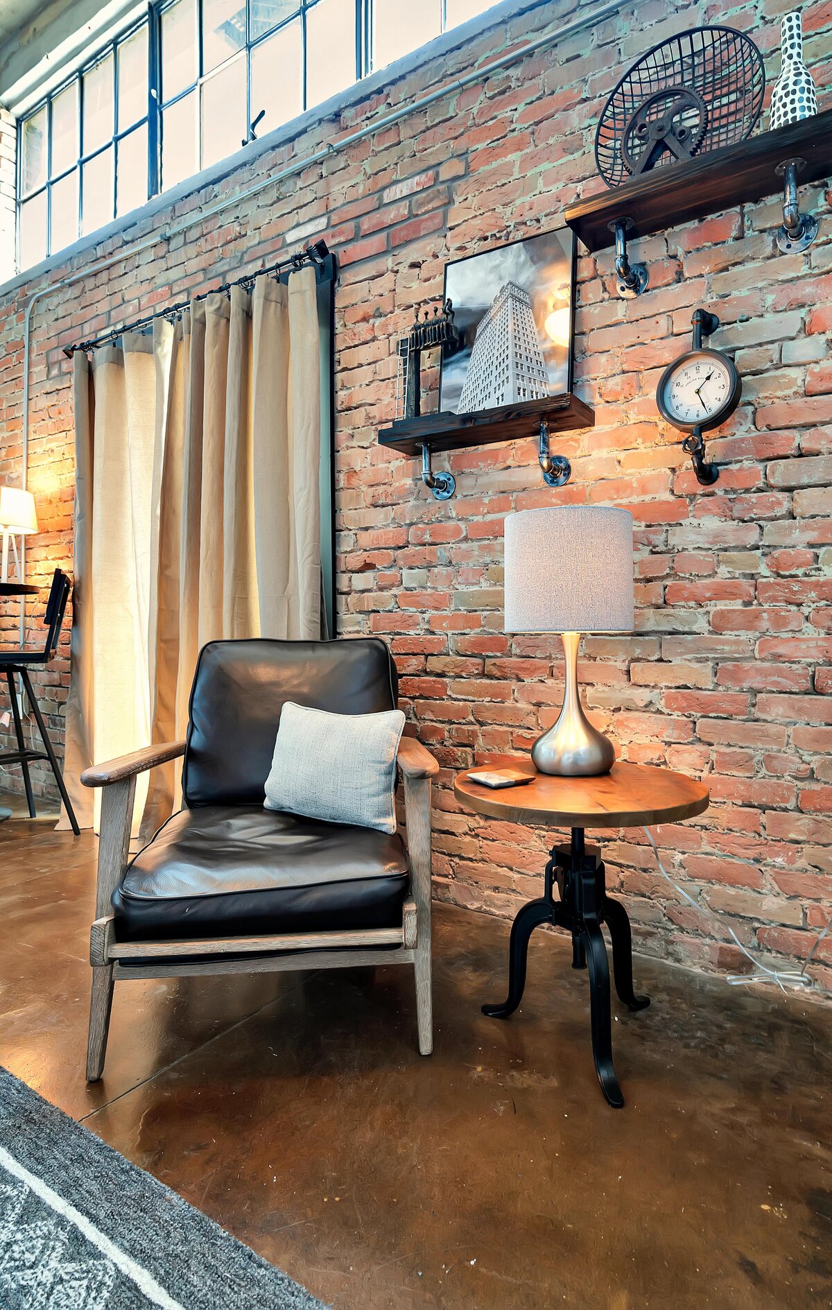 Comfortable reading nook in this two-bedroom, two-bathroom vacation rental condo in the historic Behrens building in the heart of the Magnolia Silo District in downtown Waco, TX.