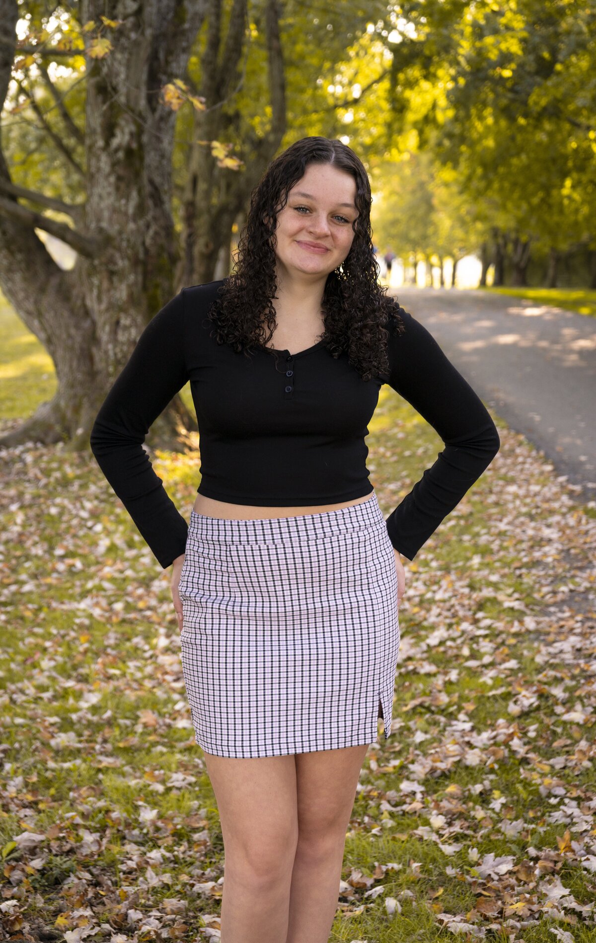 Senior photo of a young woman standing and smiling