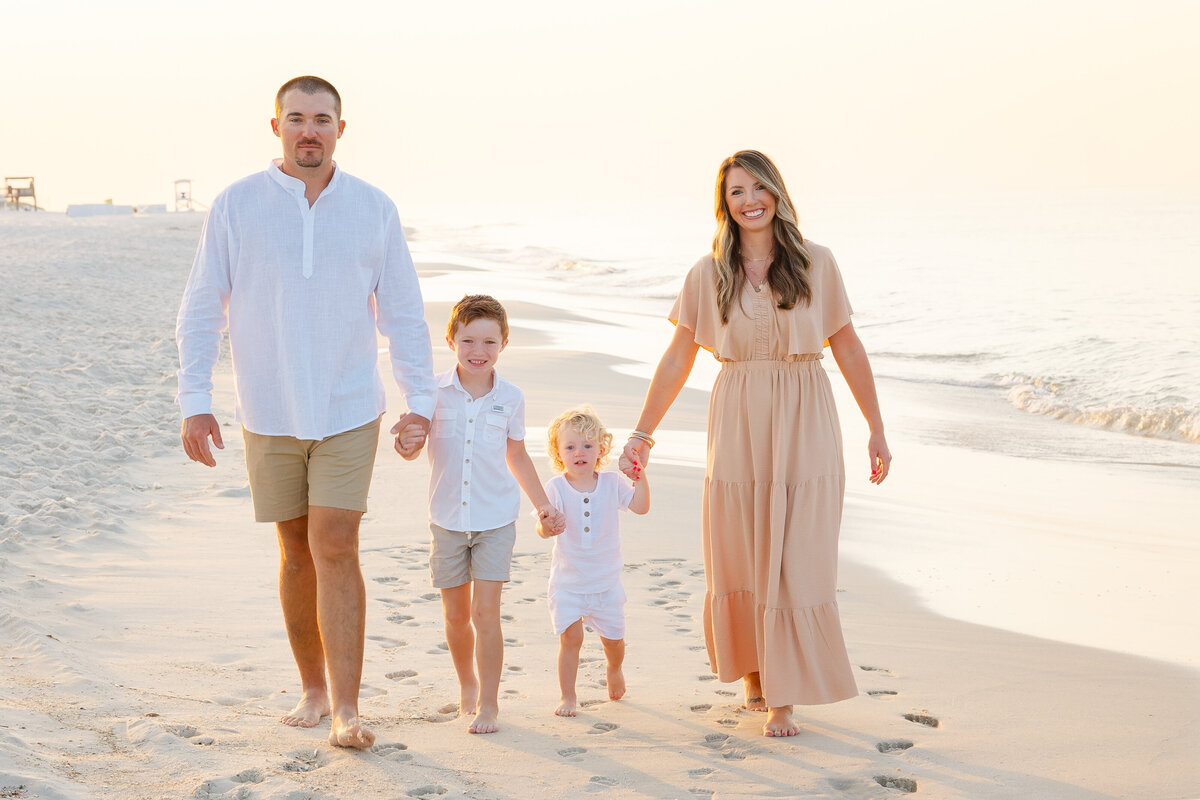 family of four walking on beach in Gulf Shores