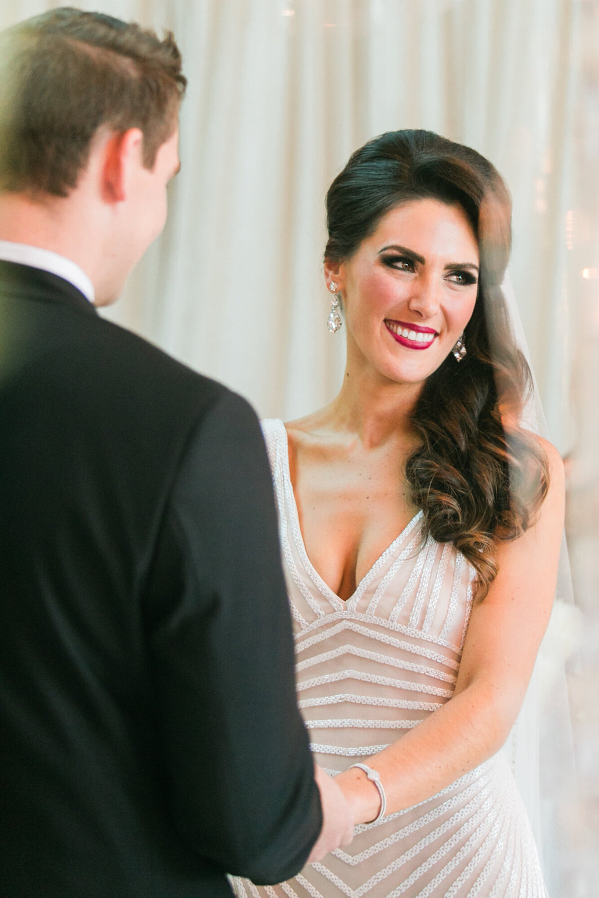 A candid moment of a bride during her wedding ceremony at Cafe Brauer in Chicago