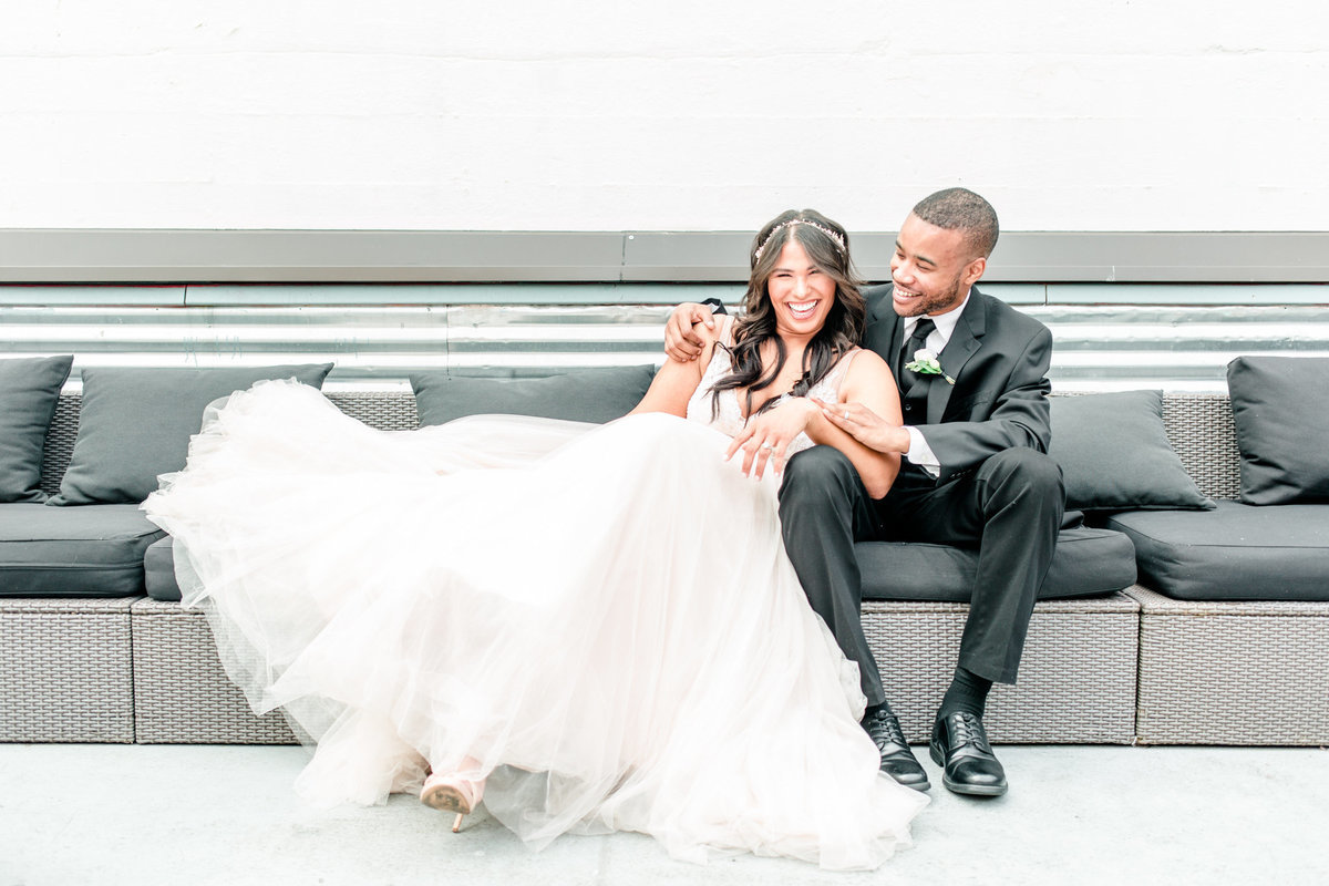 bride-groom-laughing-seattle-rooftop-wedding-venue_3563f80a379757614c1f34d792798c94