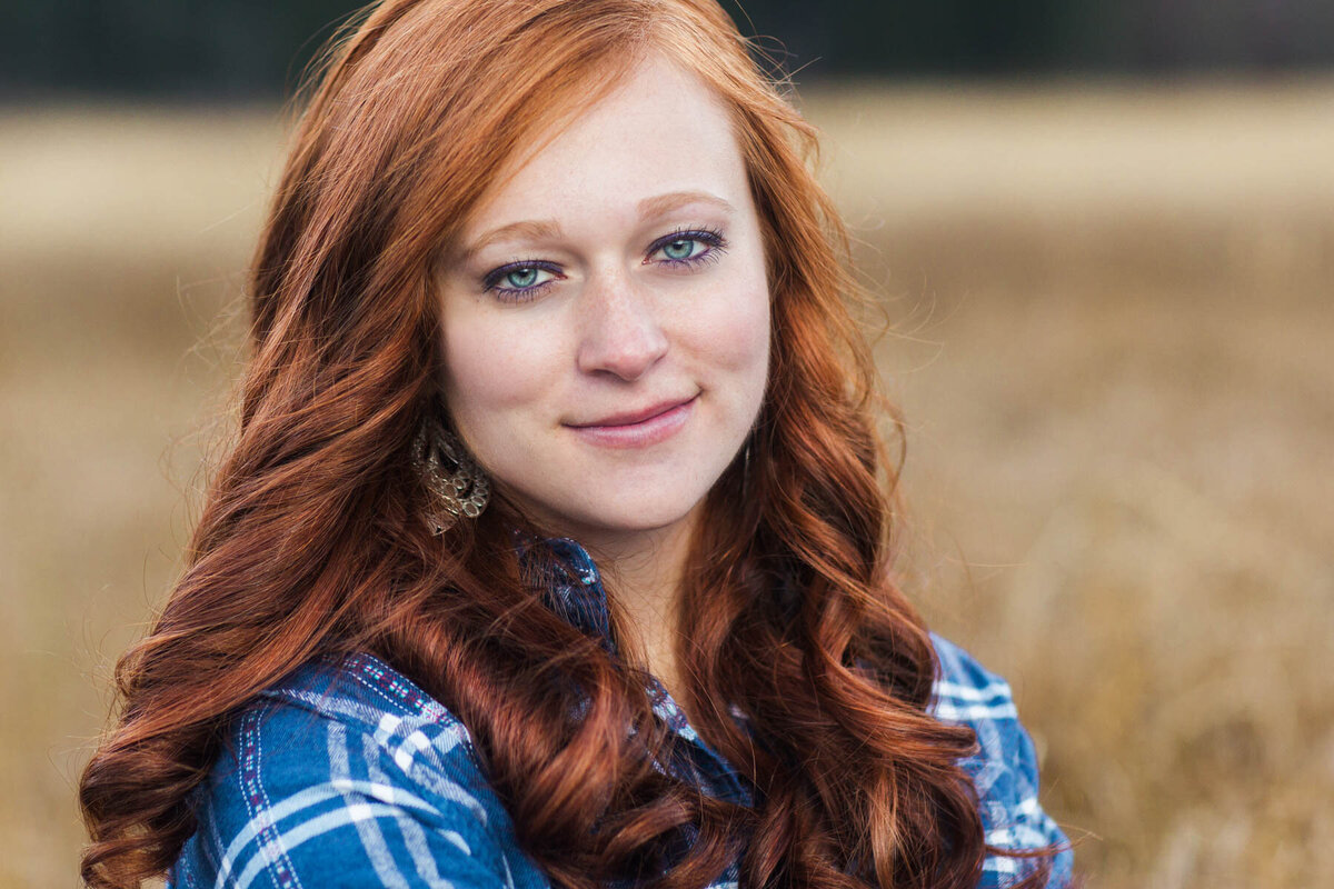 Red hair senior girl posing for photos at Silver Lake near Brighton Resort in Utah.