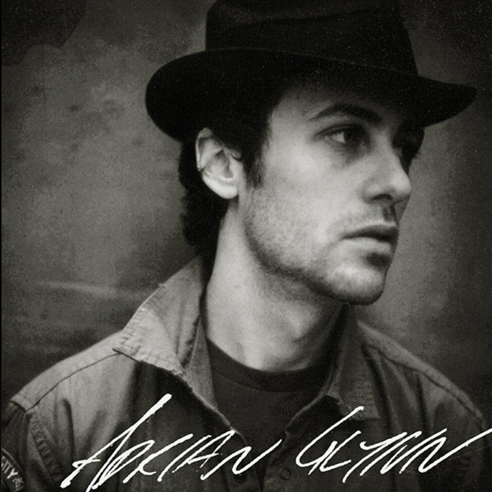 CD Cover Self Titled Adrian Glynn black and white portrait closeup of singer looking off to the right wearing a small black fedora