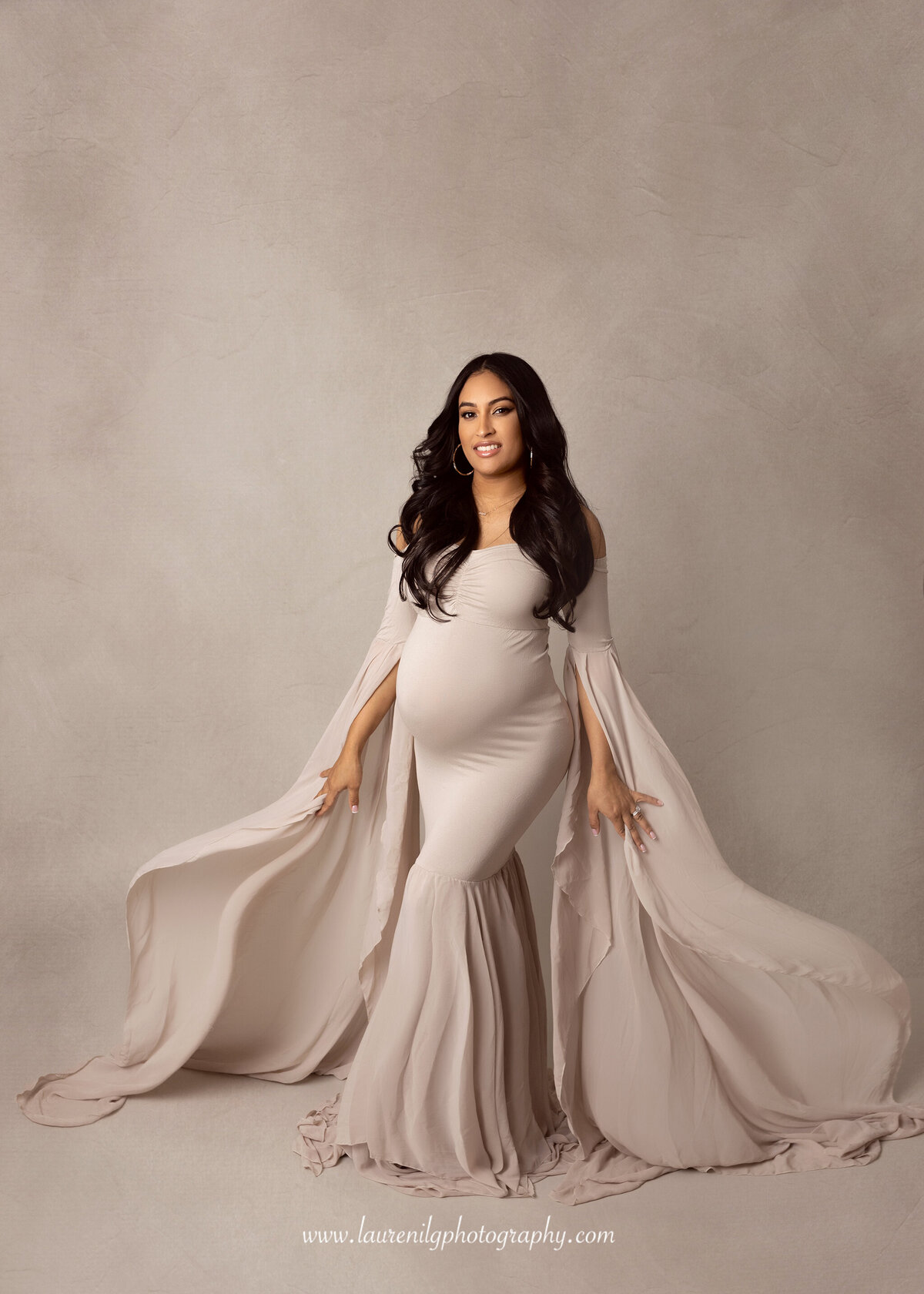 Studio maternity session with dress flowing on each side