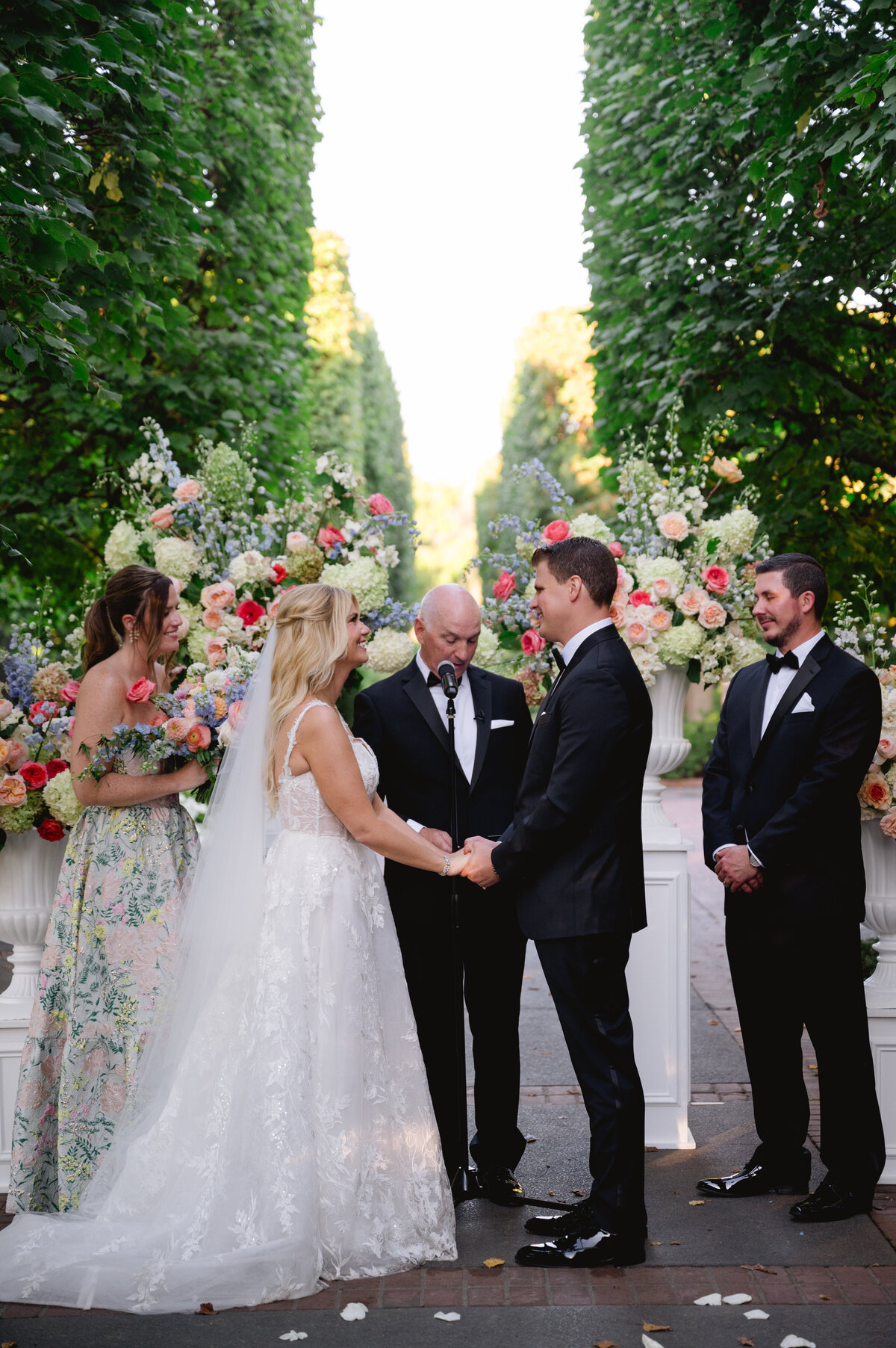 Bride and groom holding hands during their wedding ceremony at the Chicago Botanic Gardens.