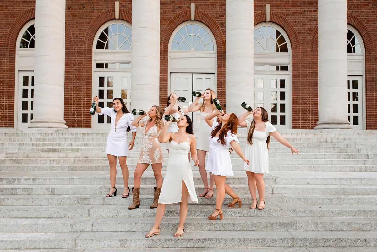 Group of girls drinking champagne standing on the stairs at Wyatt Center