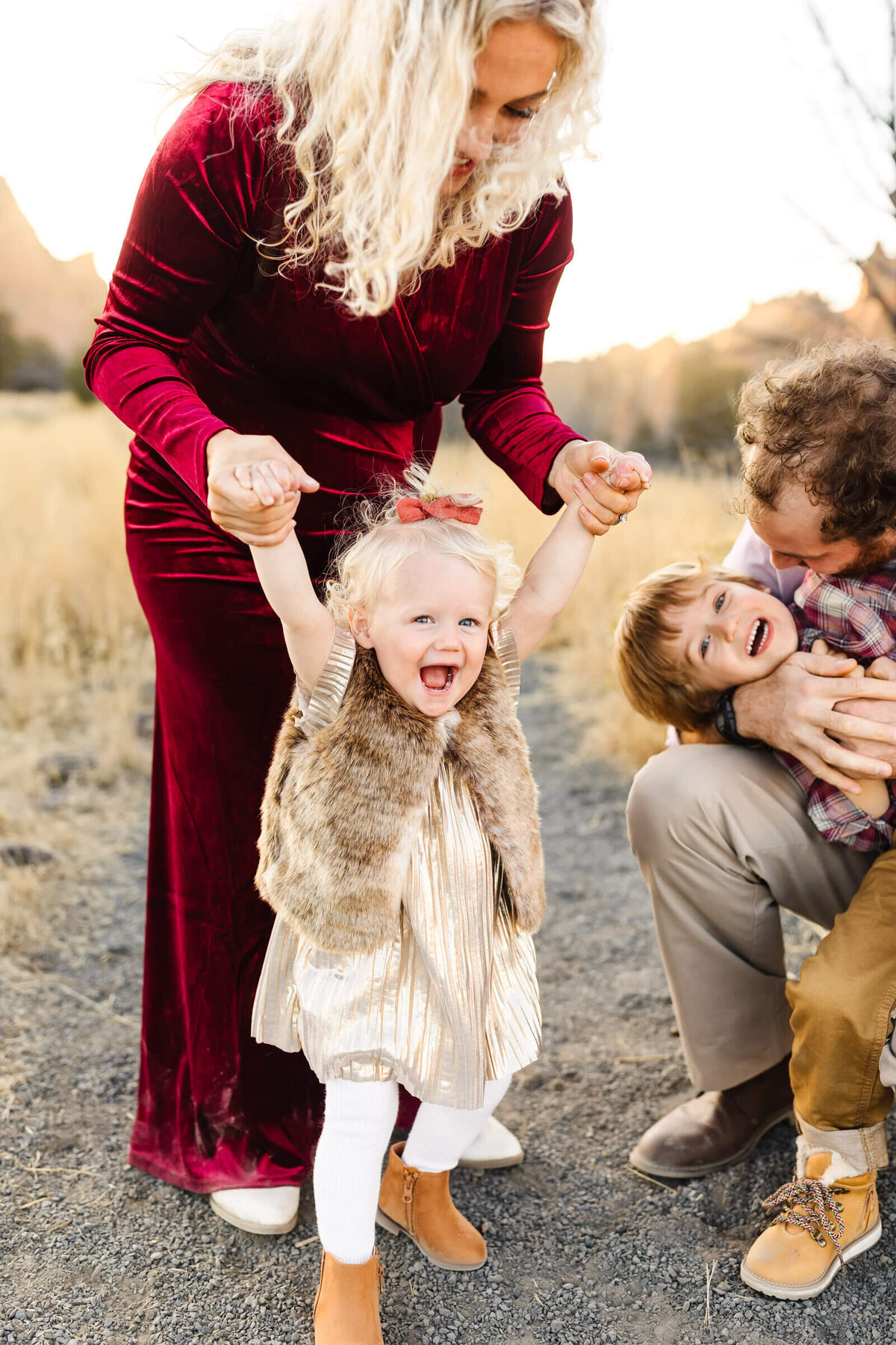 bend-family-photographer-little-blonde-girl-playing-with-pregnant-mother-at-smith-rock-1