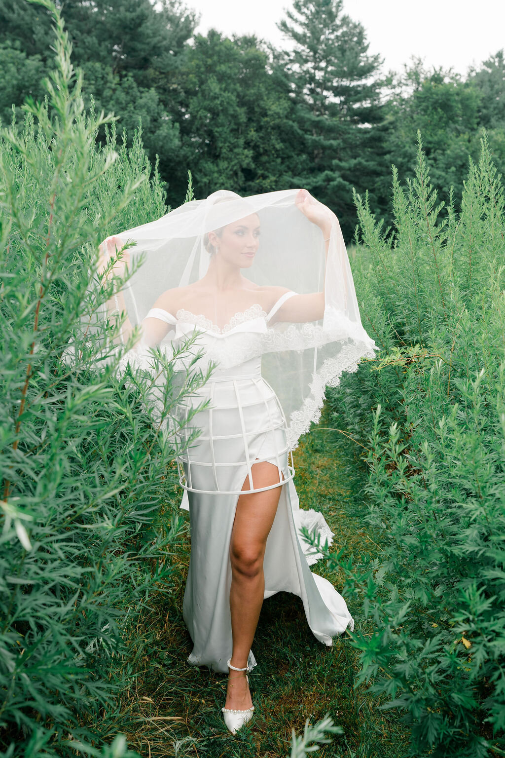 Romantic bridal moment captured under lace-edge blusher veil
