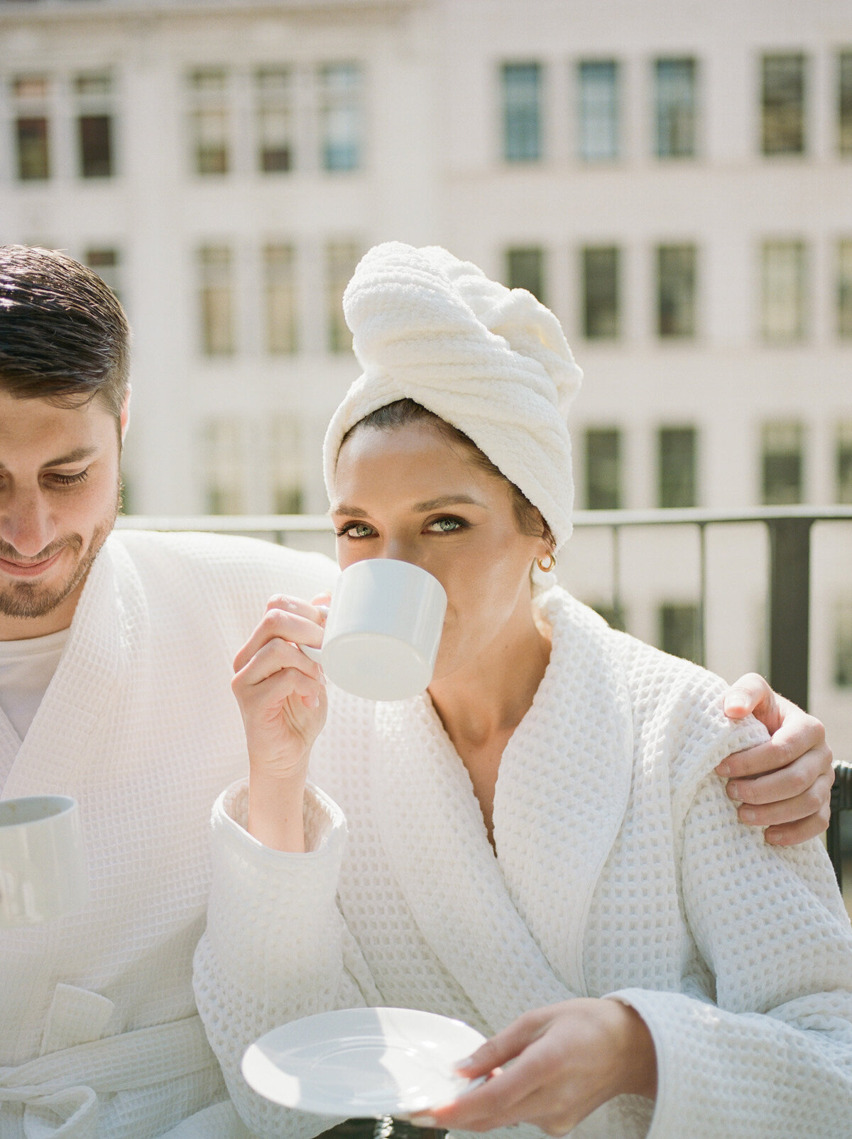 woman in bathrobe and hair towel sips coffee, wedding morning at shinola hotel