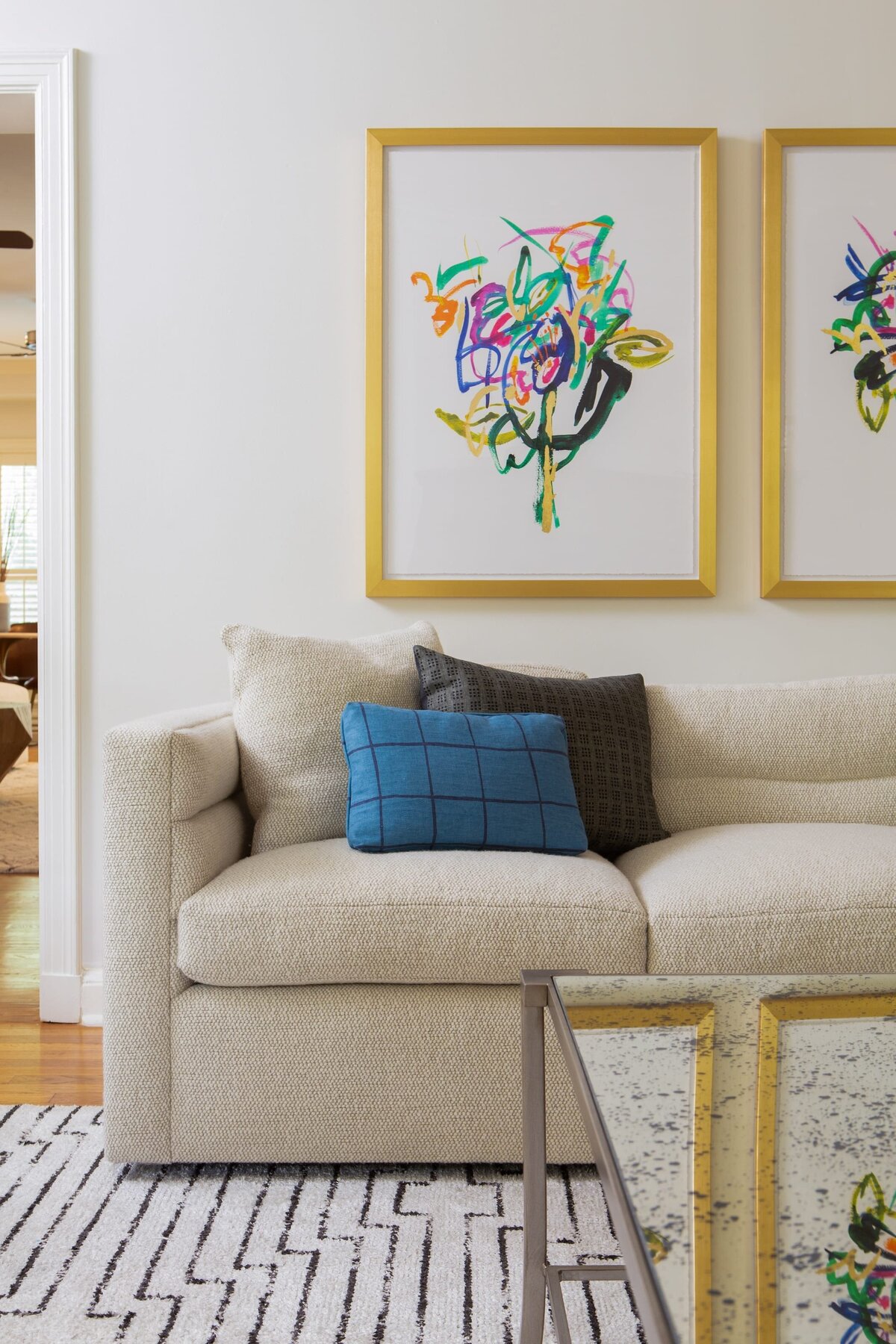 the keeping room interiors alta living room sofa with pillow and gold framed photo on wall