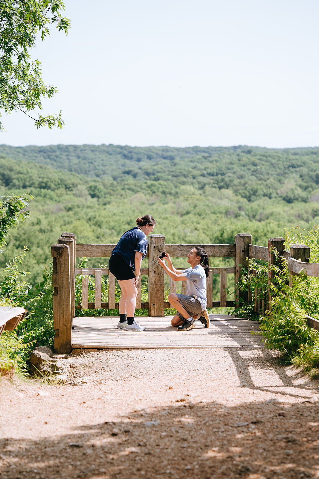 man proposing to girlfriend at a lookout spot at castlewood state park