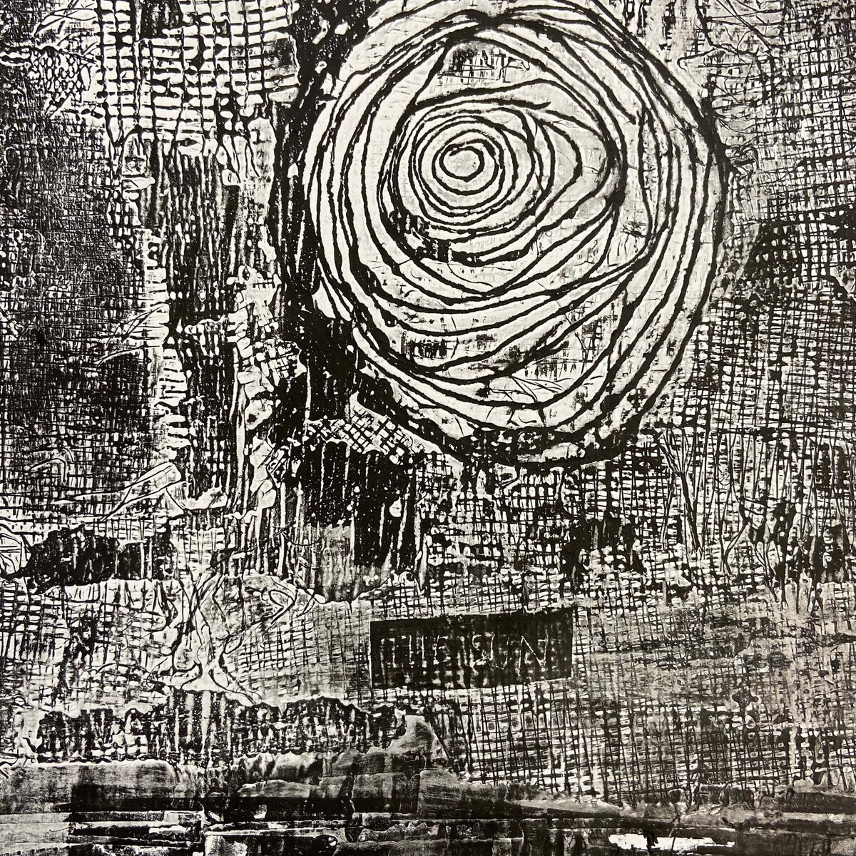 Collagraph print featuring a large spiral pattern surrounded by rich surface textures, lines, and grid-like marks.