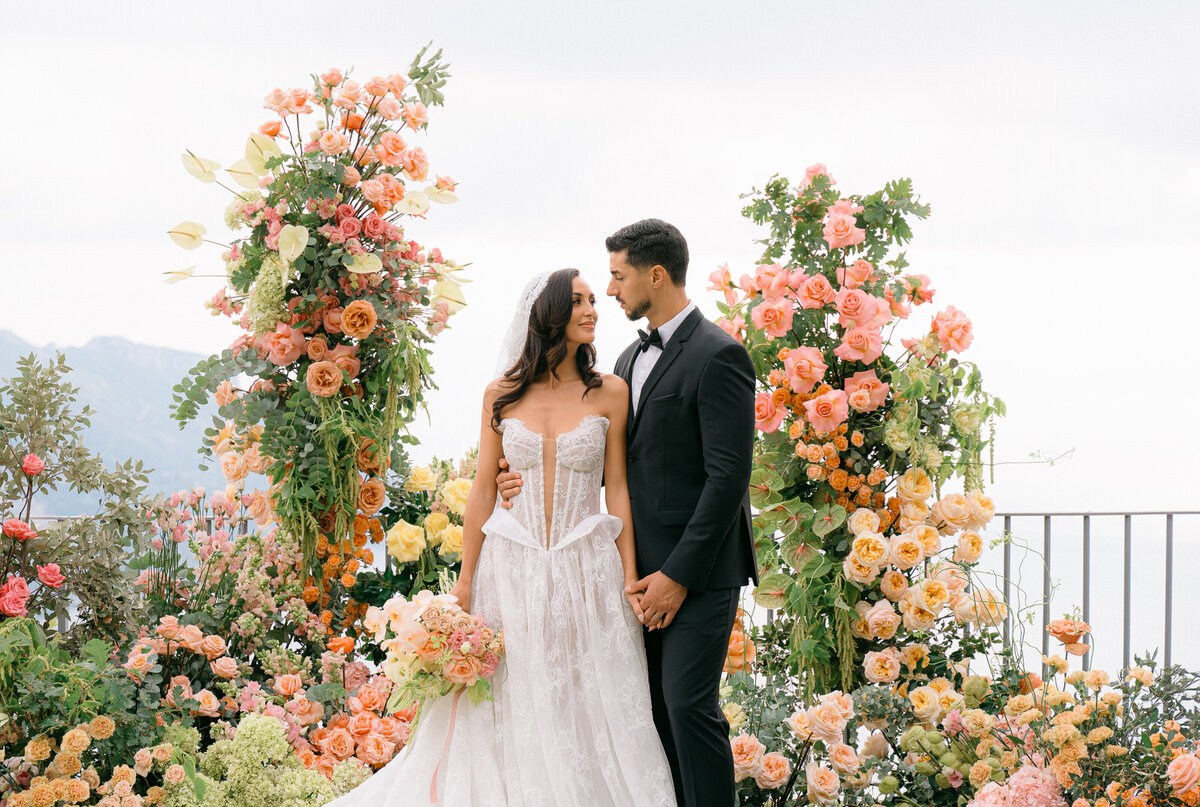 Side view of an expecting mom holding her baby bump.