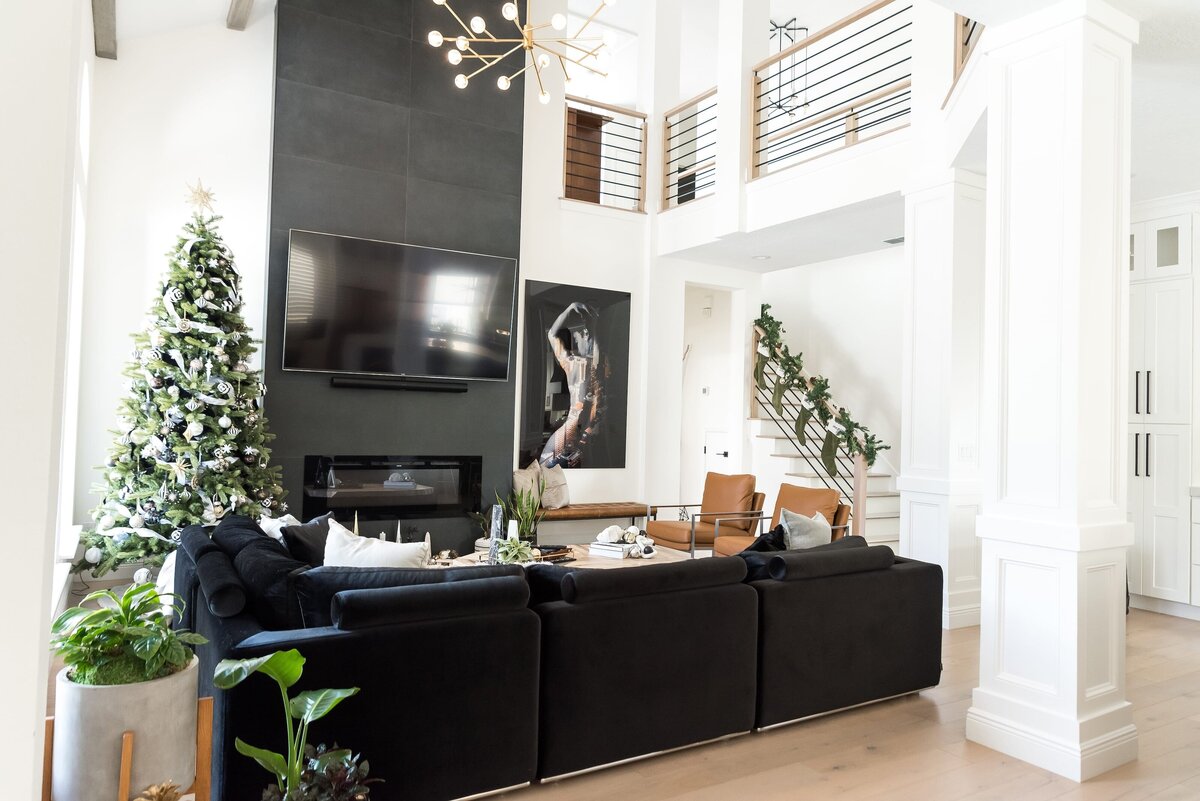dewine design orlando interior designer modern lakehouse living room with large wall art piece and black sofa
