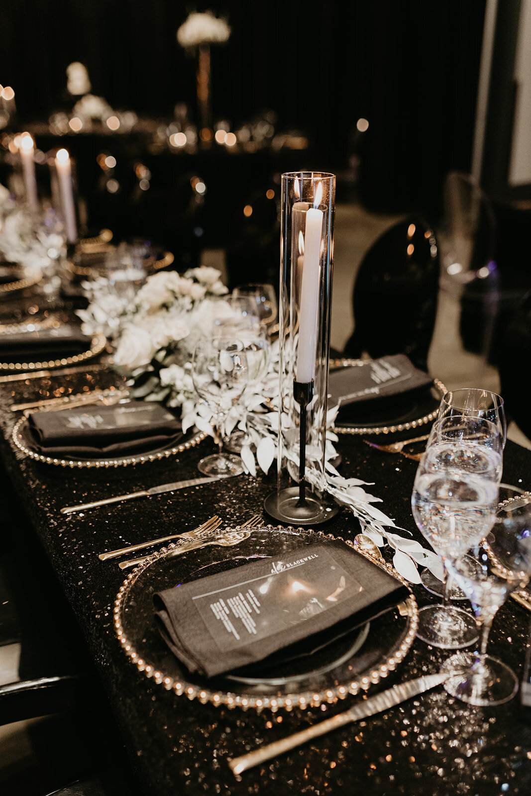 Table decor at guest seating during wedding reception.