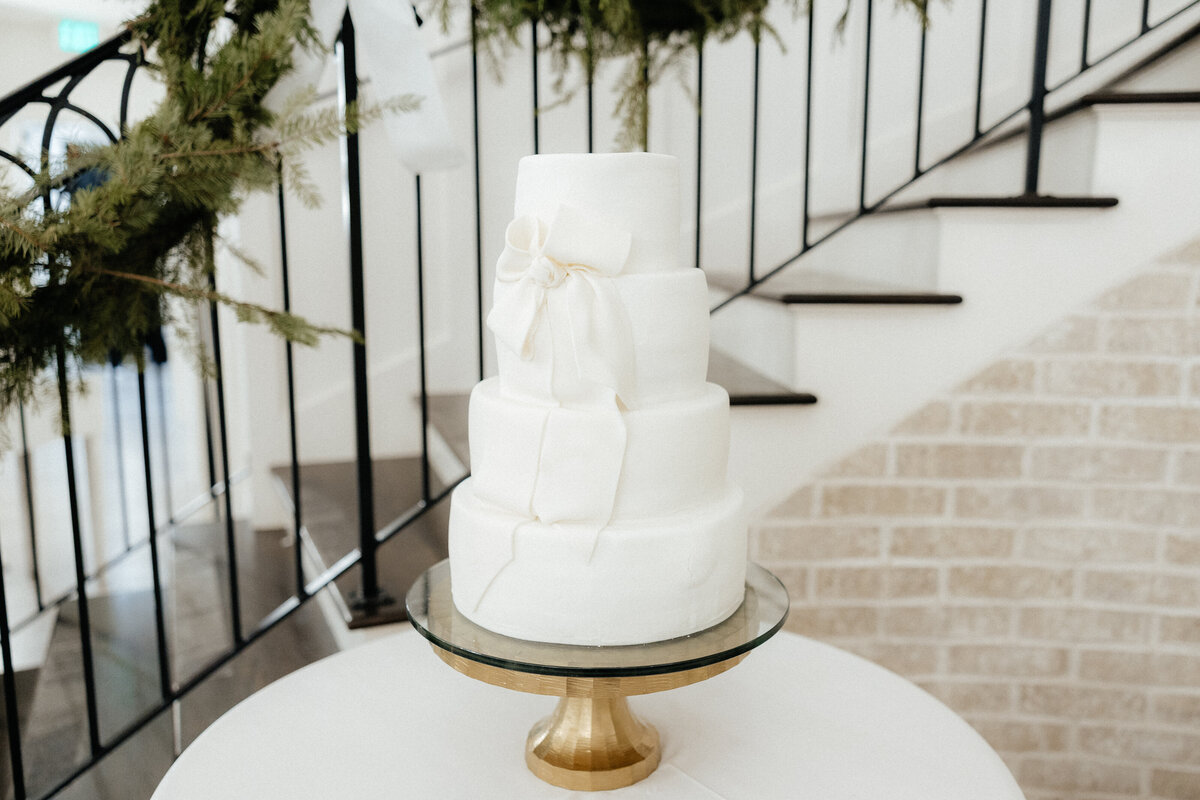 A wedding cake with bow details.
