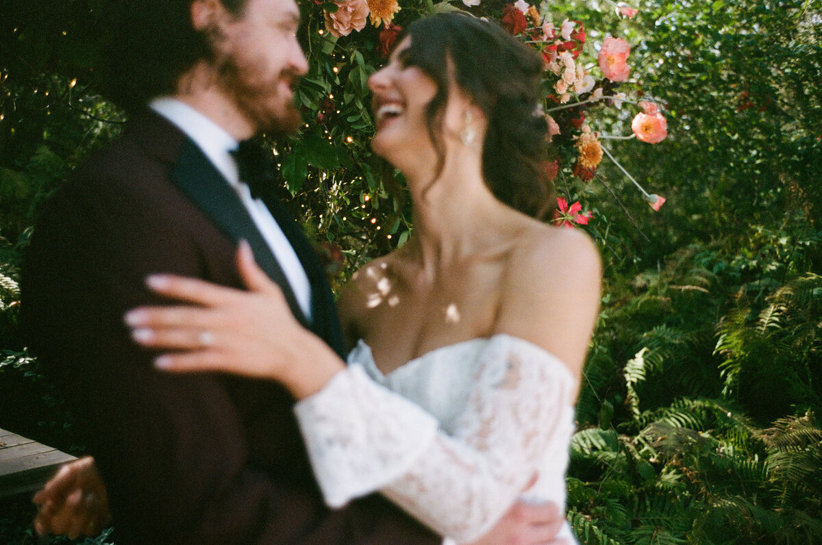close up of the bride and groom dancing and laughing