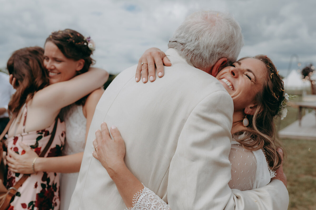 Joyful Brides Hug by Cambridge Wedding Photographer - Damien Vickers-1