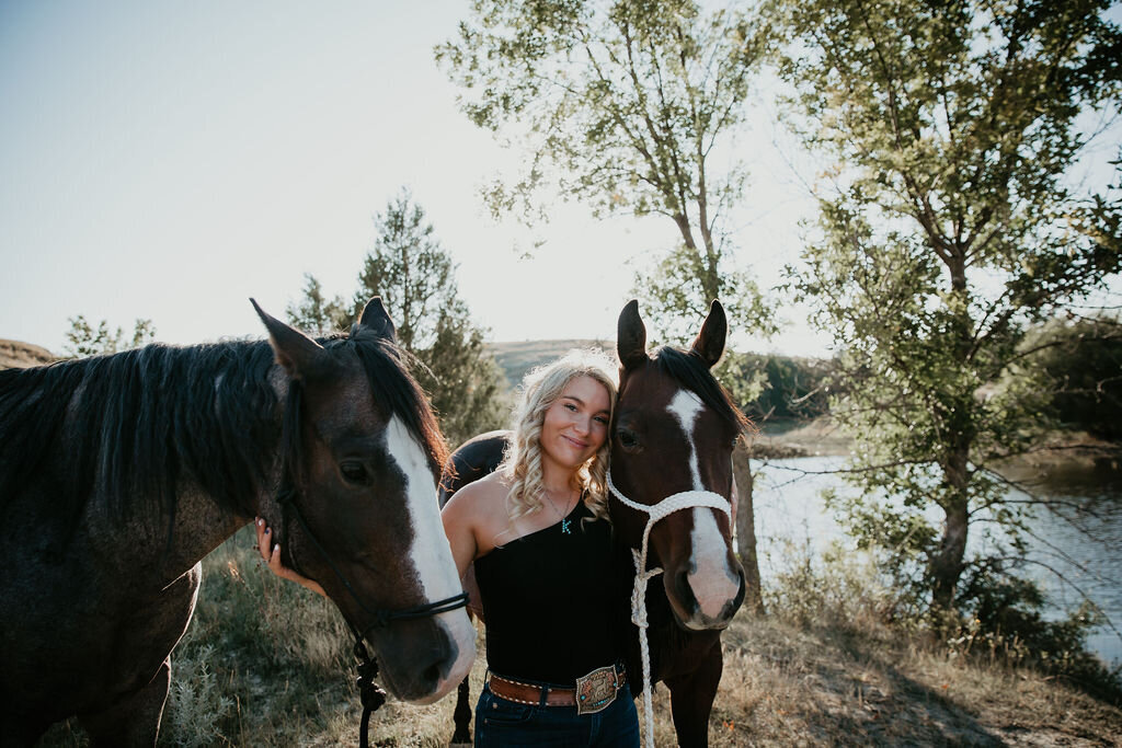 Portrait of a young woman with her horses