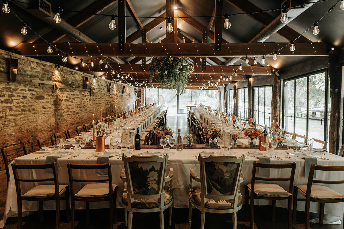 Wedding breakfast set up with long tables at Dewsall Court