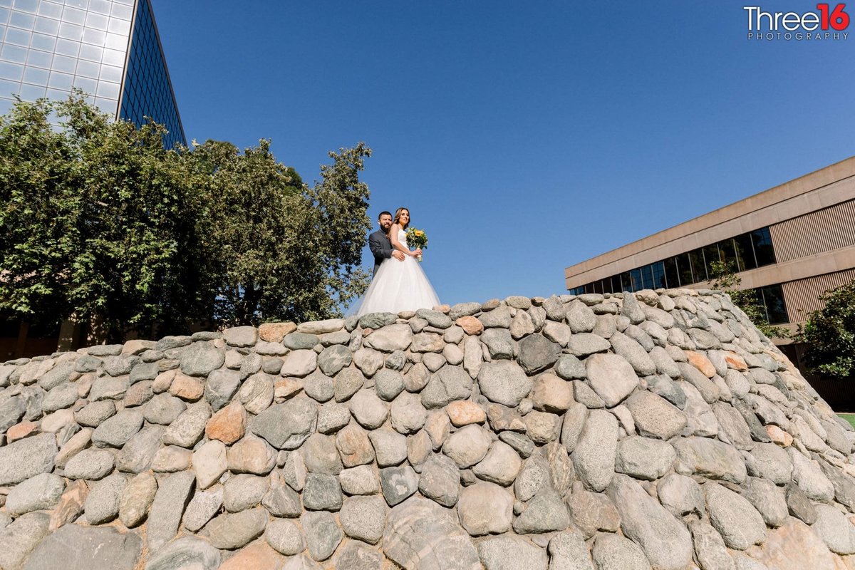 Bride and Groom pose atop the Casa Bella Wedding Venue in Anaheim