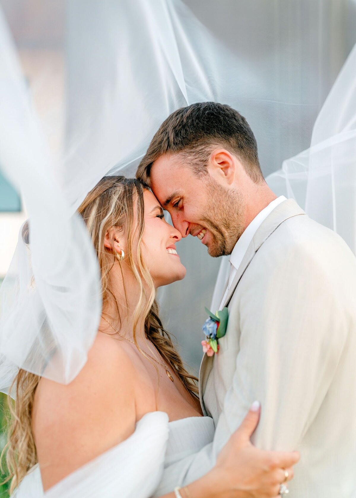 Couple-Smiling-Under-Veil