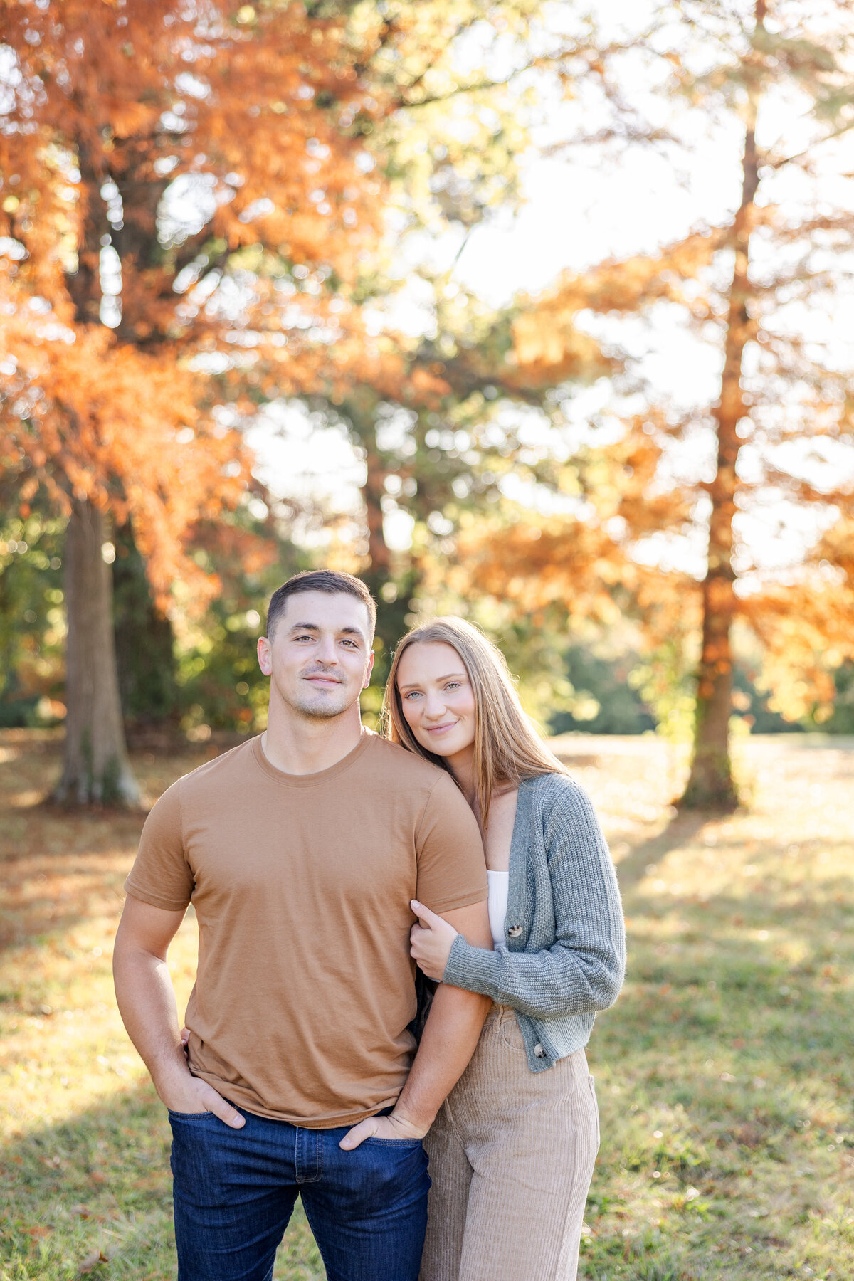 Boyfriend and girlfriend cuddled together on a warm fall day at a dog park in Cincinnati, Ohio.