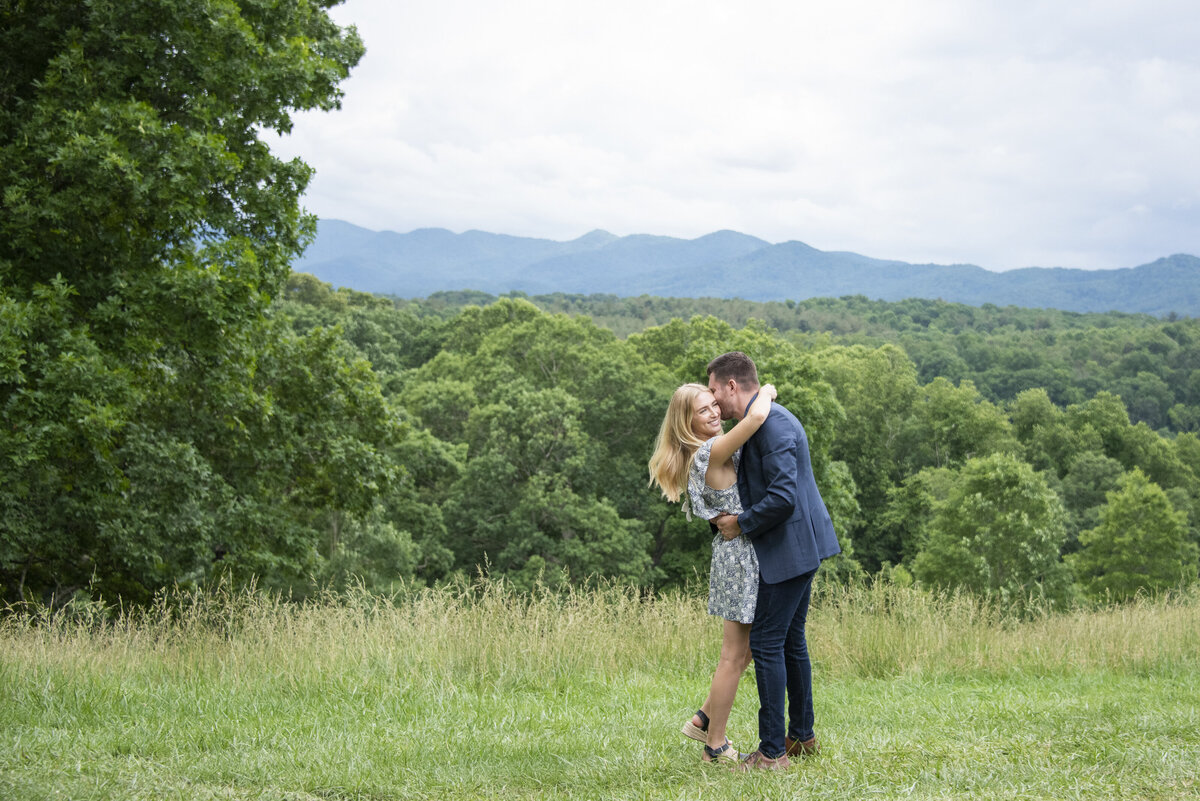 Man kissing woman Biltmore Estate mountain view Asheville, NC