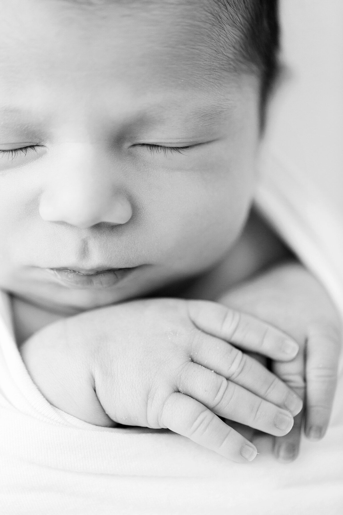 Julie Brock, Lousiville KY newborn photographer, takes photo of sleeping newborn baby at her St Matthews Studio