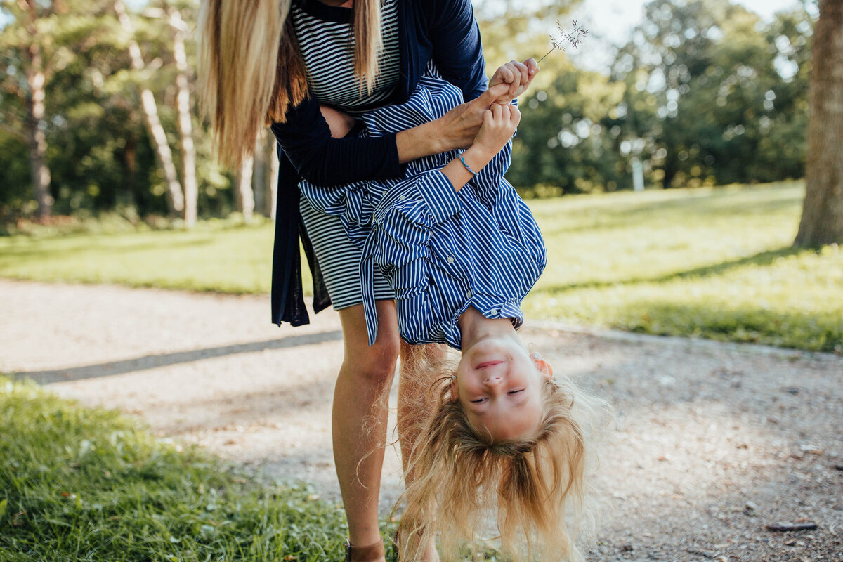 mom-holding-daughter-upside-down