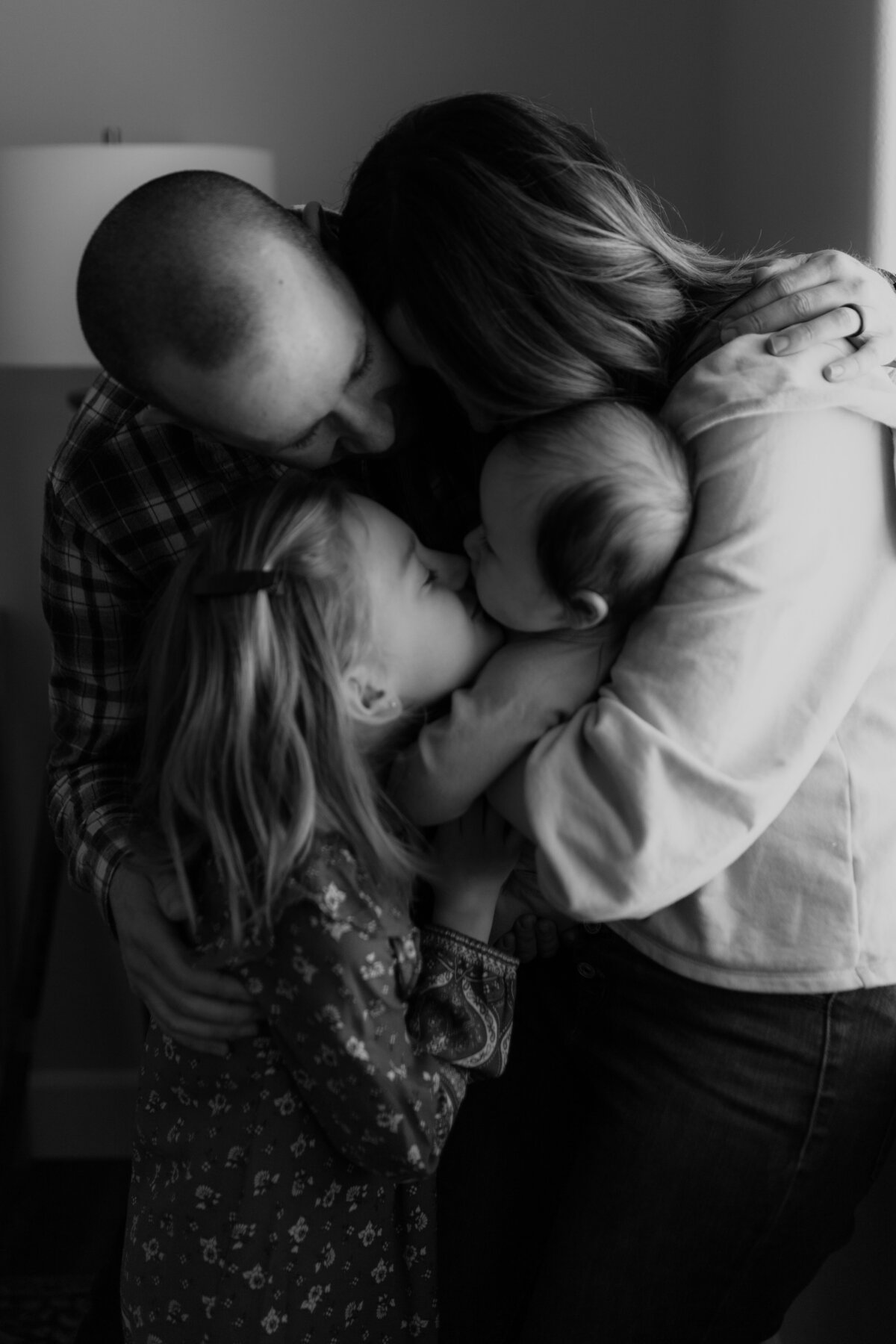 black and white image family embracing